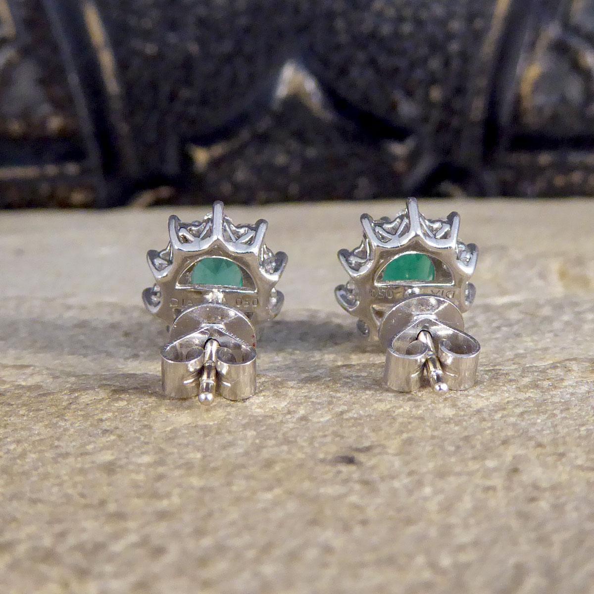Oval Cut Contemporary Emerald and Diamond Cluster Earrings in 18ct White Gold For Sale