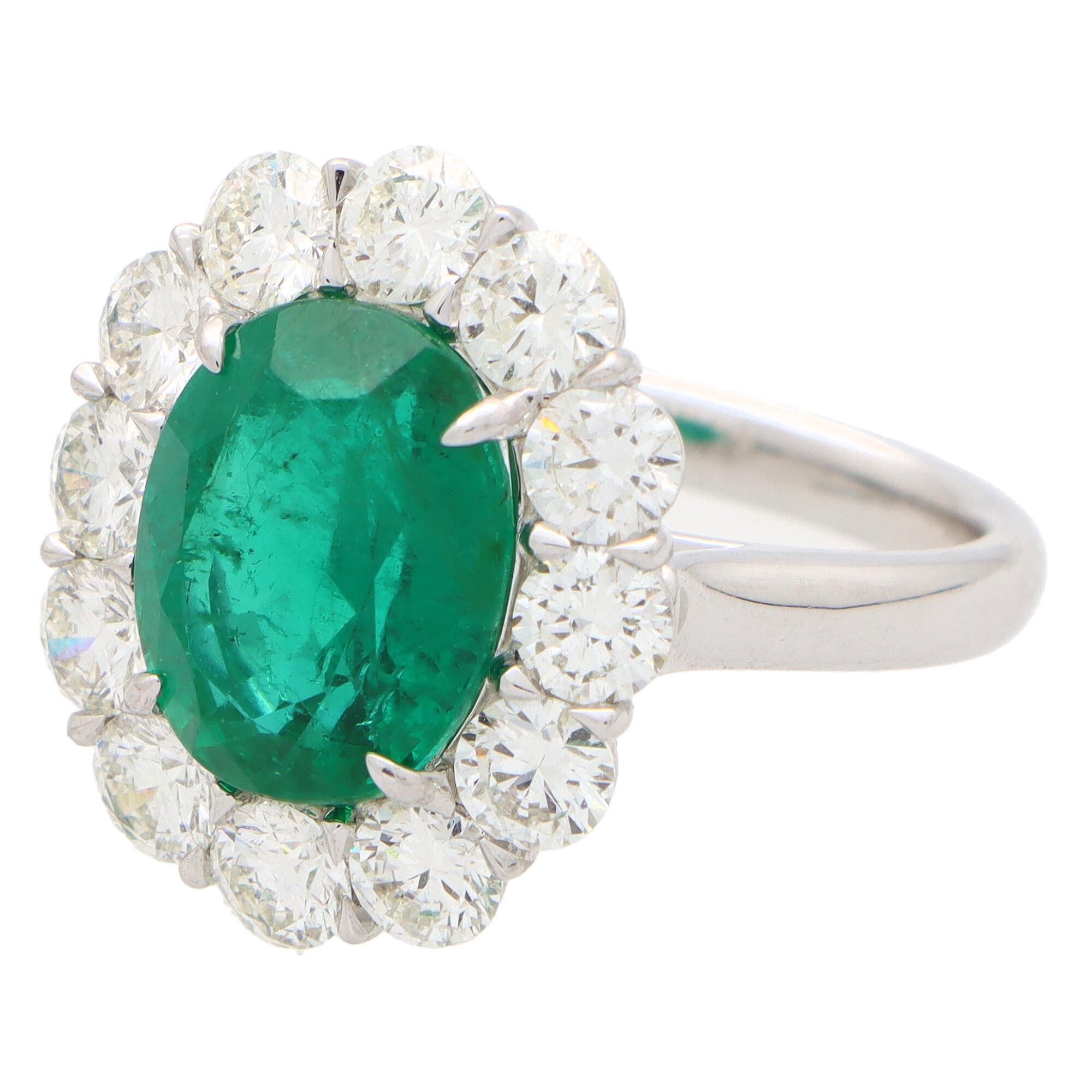 Oval Cut Contemporary Emerald and Diamond Cluster Engagement Ring Set in Platinum 