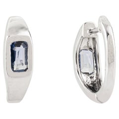 Contemporary Emerald Cut Blue Sapphire Huggie Hoop Earrings in 14K White Gold