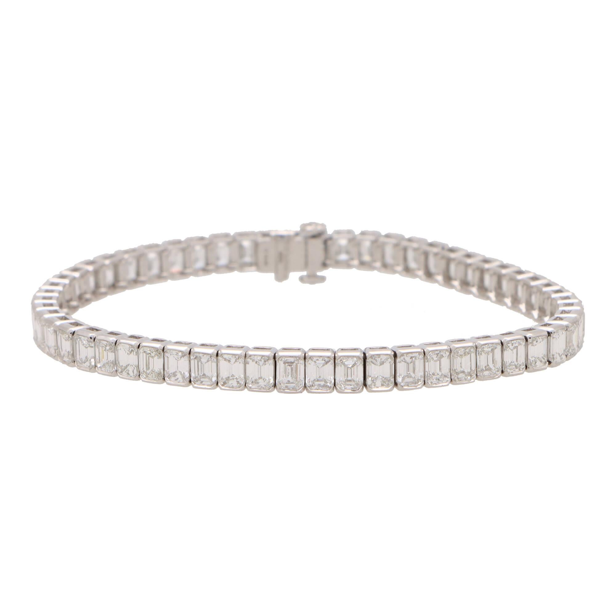 A beautiful contemporary emerald cut diamond line bracelet set in platinum.

The bracelet is composed of a grand total of 56 emerald cut sparkly diamonds, all of which are rubover set securely. The bracelet is secured with a push tongue clasp and
