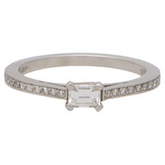 Contemporary Emerald Cut Diamond Ring with Diamond Shoulders in Platinum