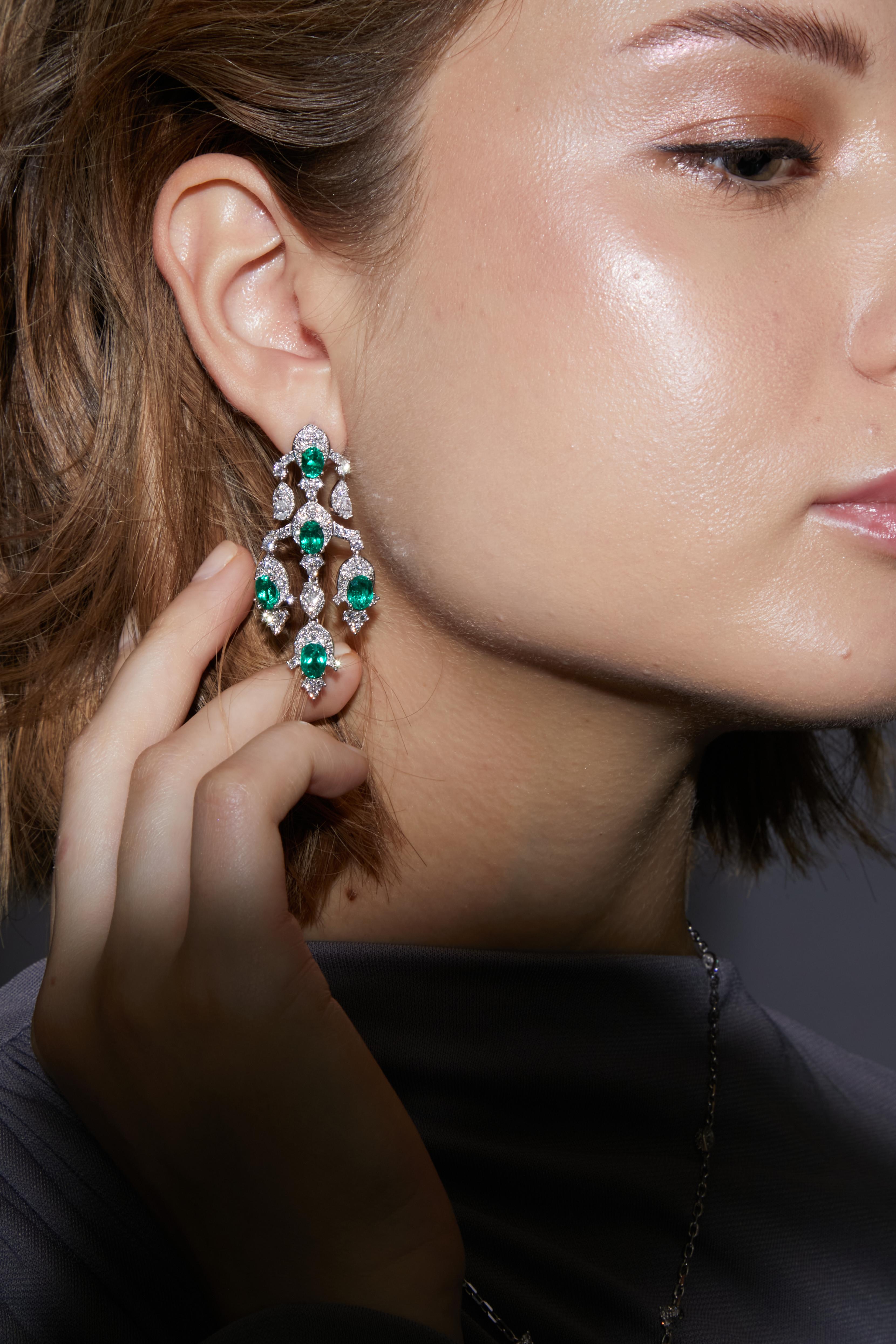 Regalia Earrings by Sunita Nahata Fine Design. A statement piece created using the finest Emeralds. Featuring subtle playful dangles these are a must have to glam up your evening look.

Contemporary Emerald Earrings in 18 Karat White Gold with