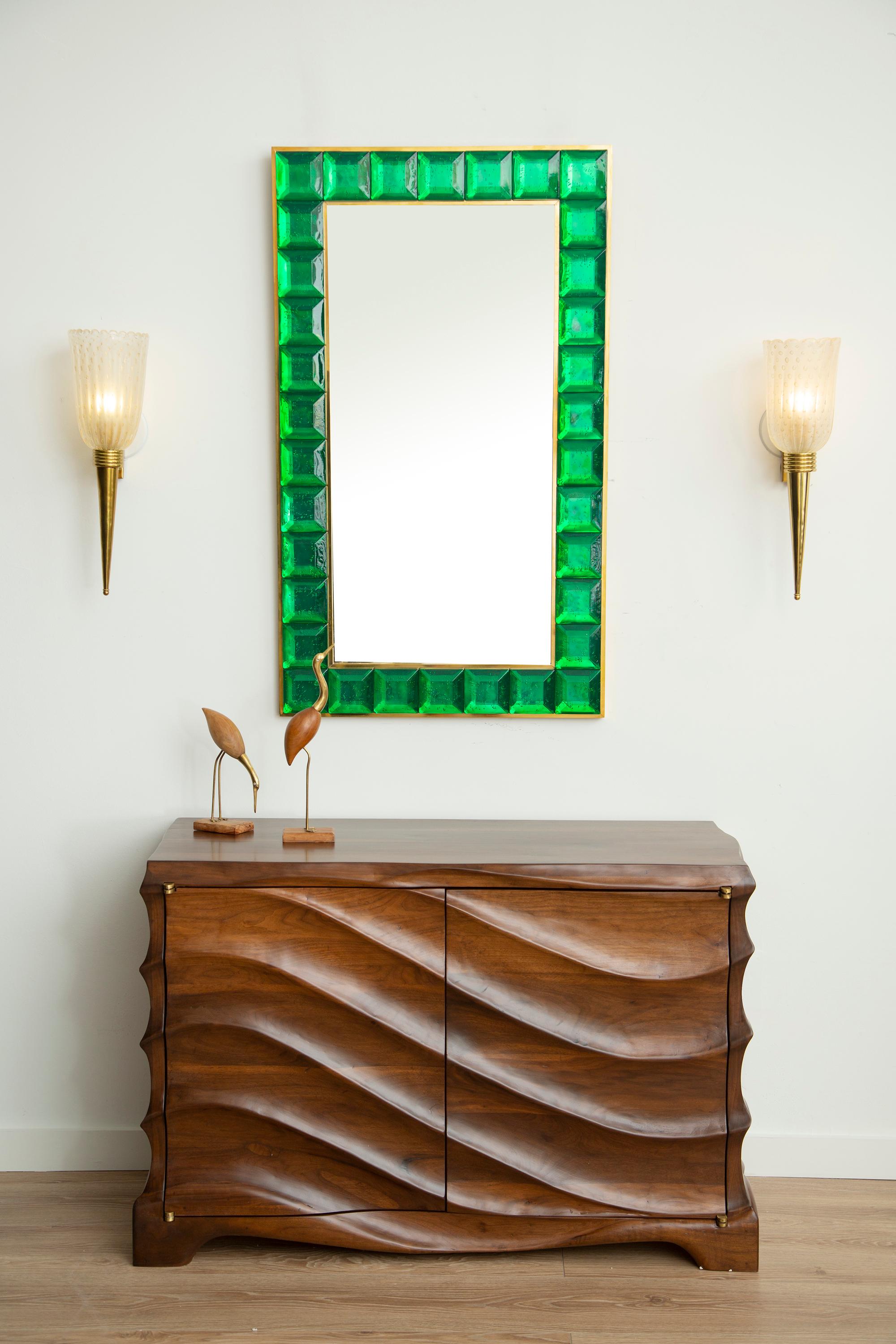 Contemporary emerald green square diamond cut Murano glass mirror.
Vivid and intense emerald green glass block with naturally occurring air inclusions throughout 
 Highly polished faceted pattern
 Brass gallery
 Luxury handcrafted by a team of