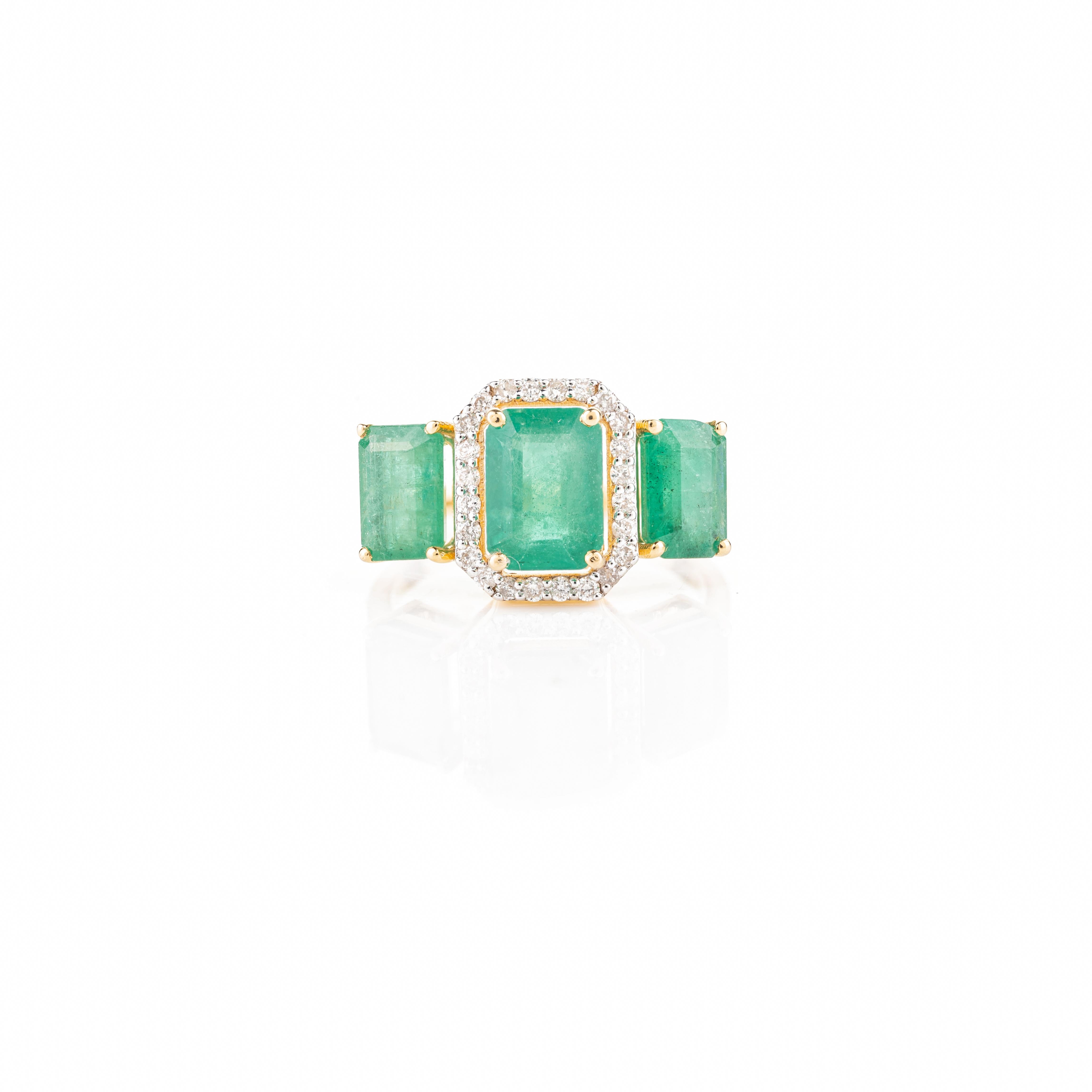 For Sale:  Contemporary Emerald Three Stone Ring with Halo Diamonds in 18k Yellow Gold 3