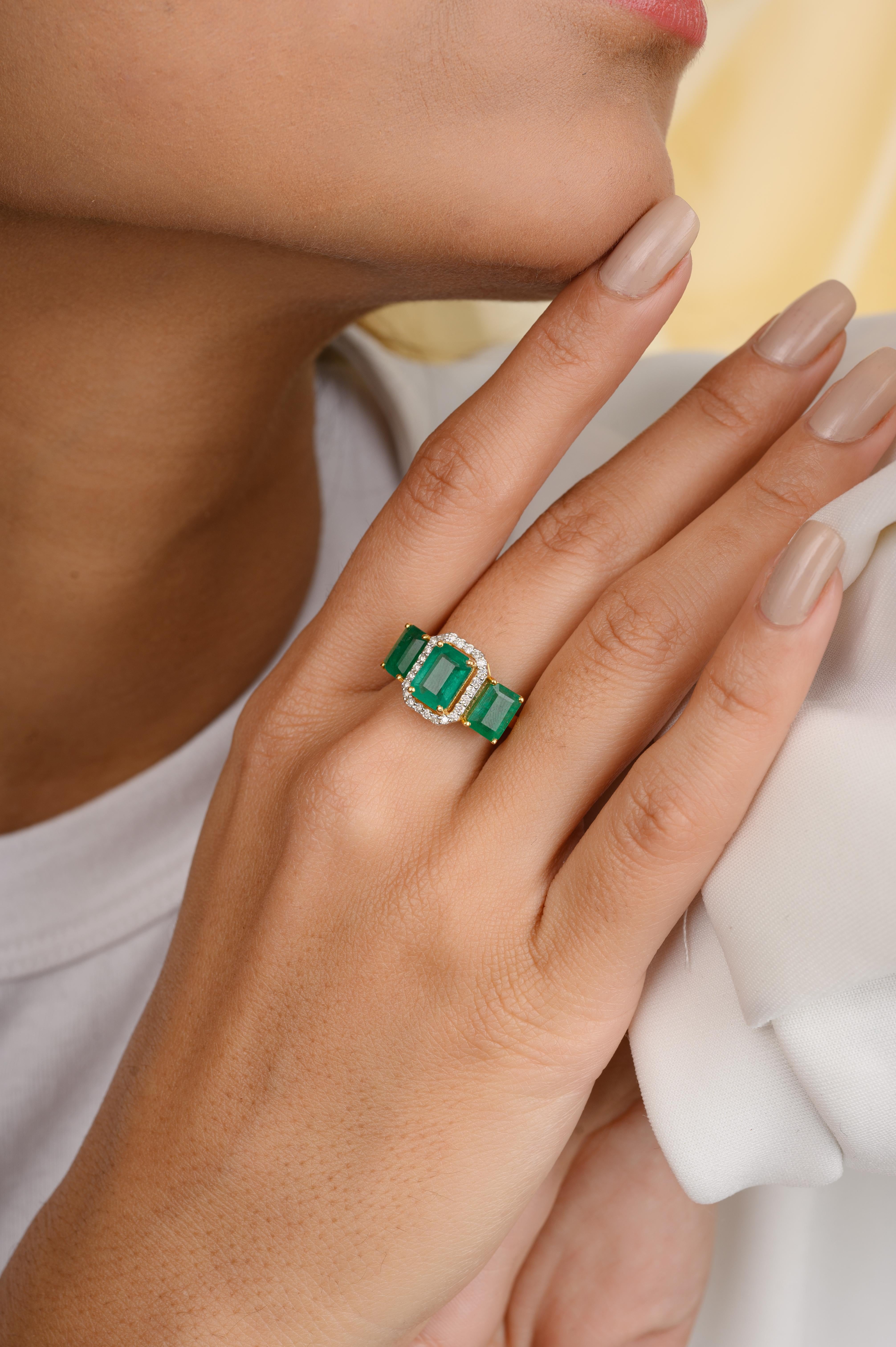 For Sale:  Contemporary Emerald Three Stone Ring with Halo Diamonds in 18k Yellow Gold 2