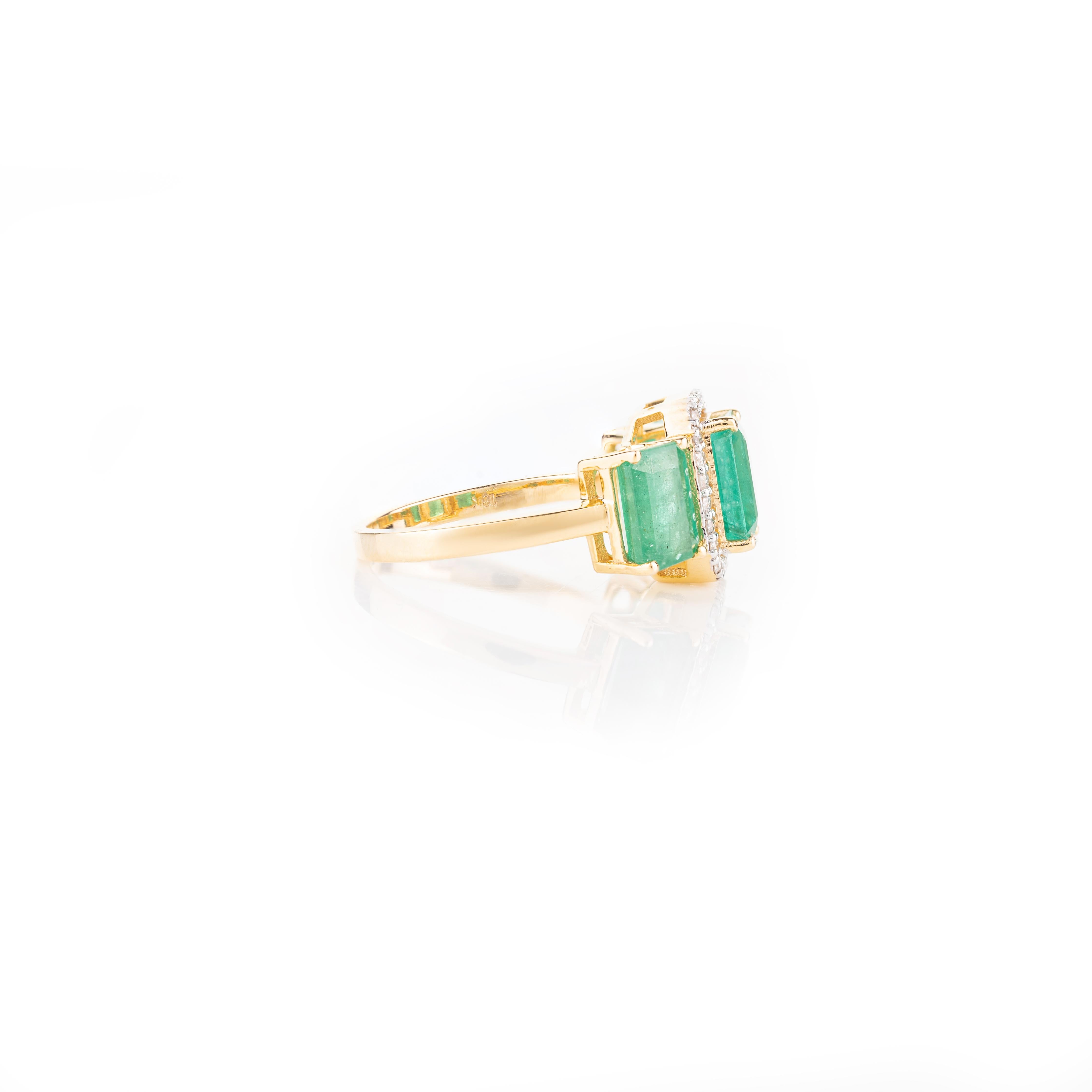 For Sale:  Contemporary Emerald Three Stone Ring with Halo Diamonds in 18k Yellow Gold 4