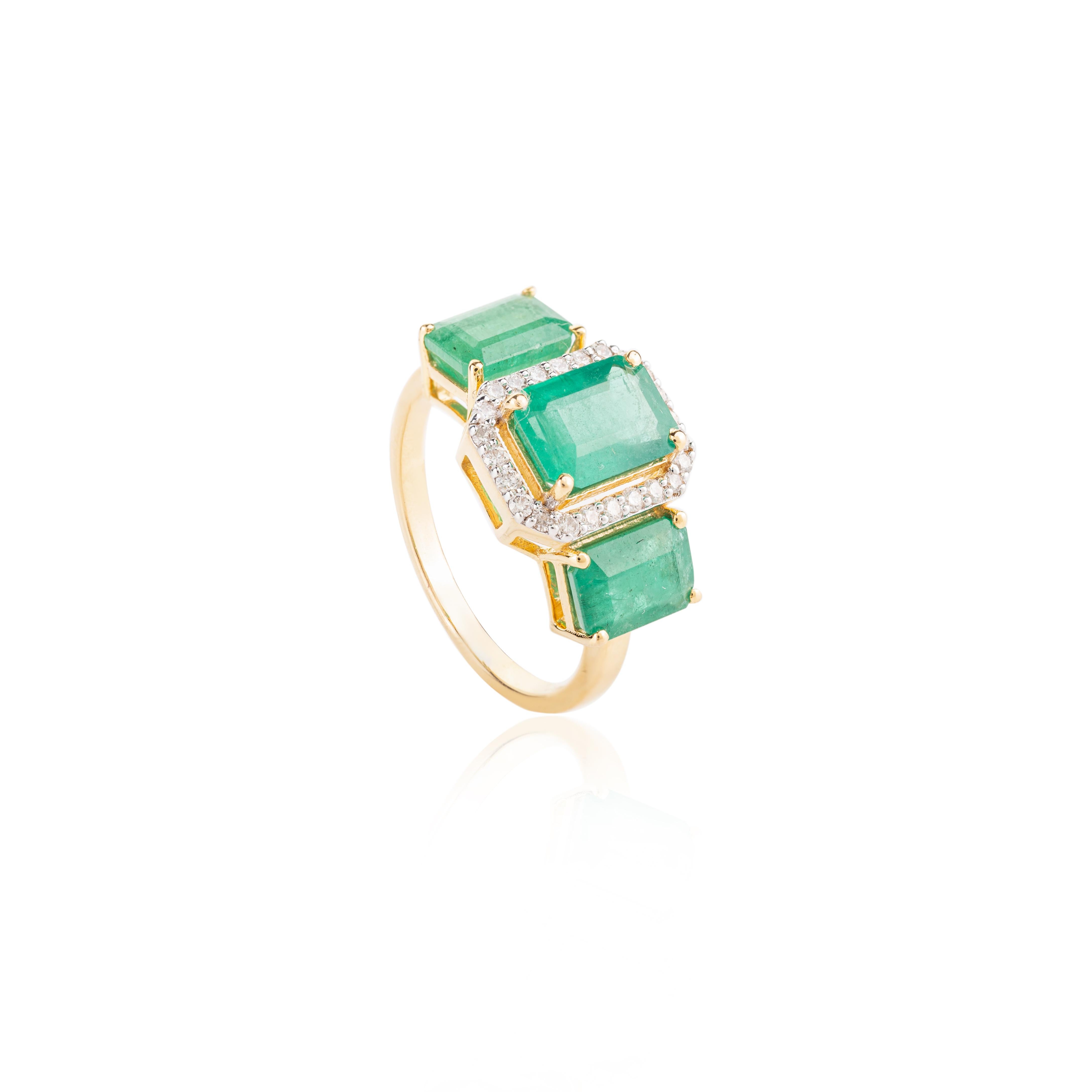 For Sale:  Contemporary Emerald Three Stone 18k Yellow Gold Ring with Halo Diamonds 7