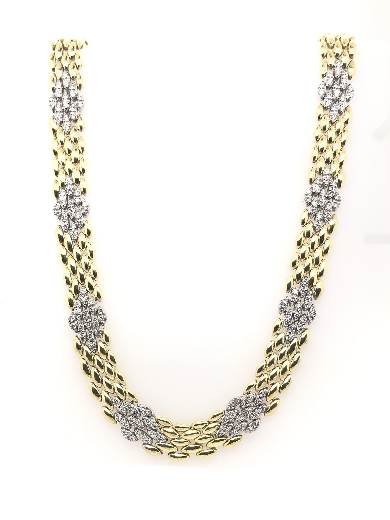 This stunning contemporary estate piece is crafted from 18K gold and white gold links. The necklace measures approximately 17 inches in length. The piece features 81 diamond links featuring 162 diamonds total. The necklace has an estimated combined