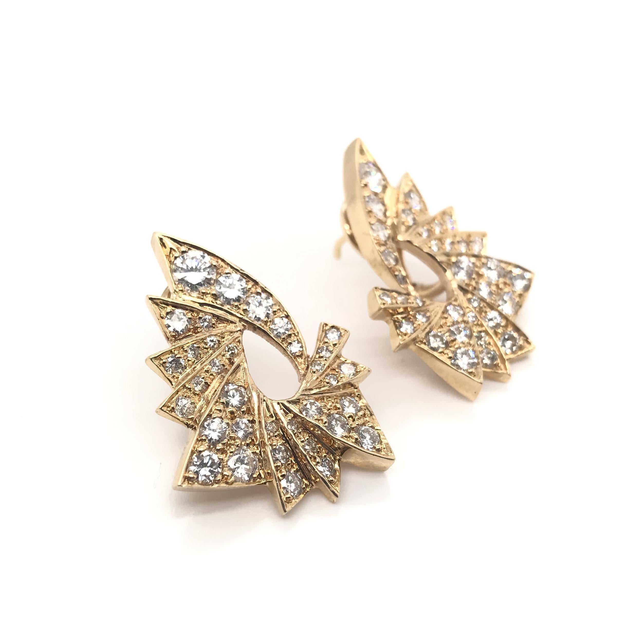 These gorgeous diamond cluster earrings are a contemporary estate piece. Each earring features 34 diamonds of varying sizes. The earrings have an approximate combined diamond weight of 3 carats. The diamonds grade approximately G in color and VS1 in
