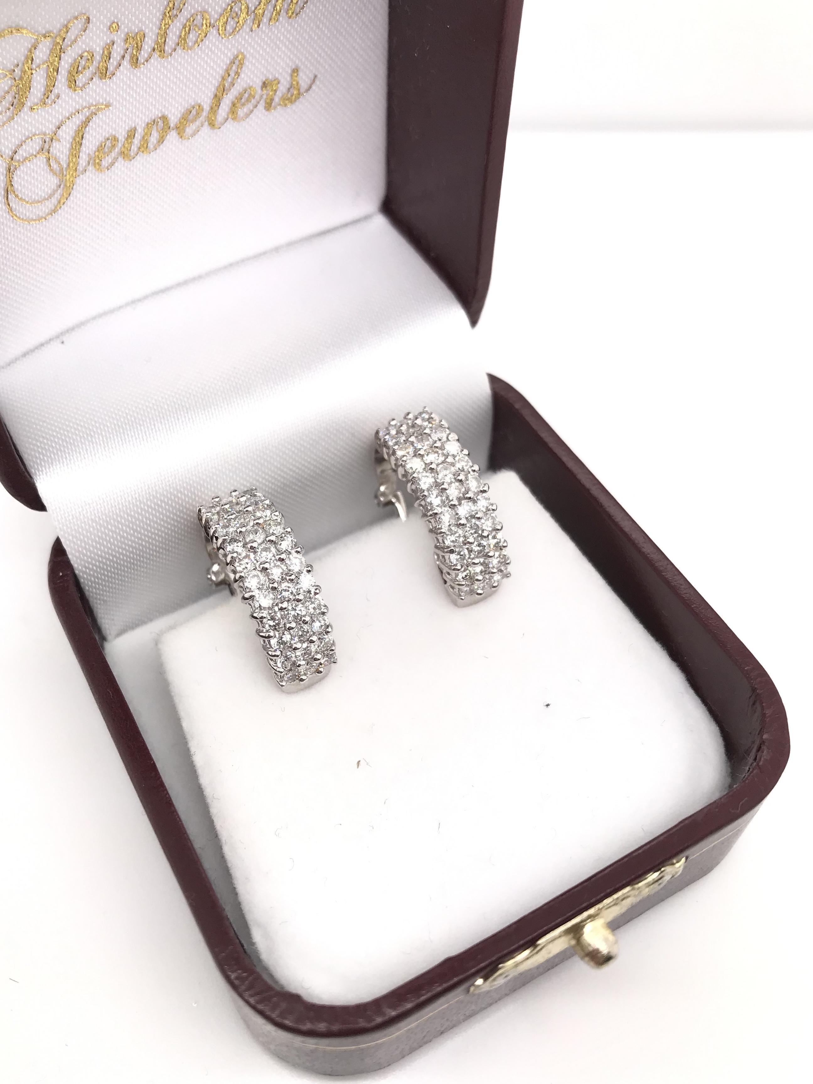 These contemporary estate earrings feature a very easy to wear half hoop style, perfect for everyday wear. The settings are 14K white gold and each earring features 30 sparkling diamonds. The earrings have a combined total diamond weight of