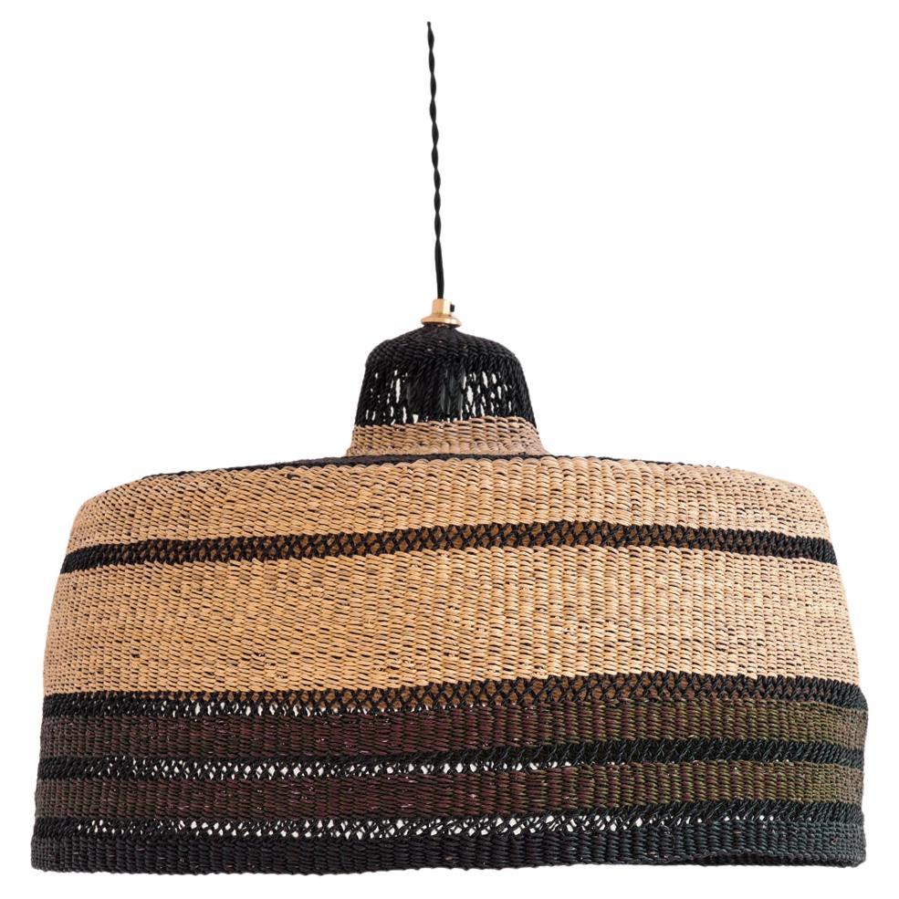 Large woven pendant lamp : 
Warm and earthy
Colour: Noisette (earthy brown)

Do you love handmade objects but are looking for something more elevated to hang in your room? This large pendant lamp with black, earthy browns and natural stripes will