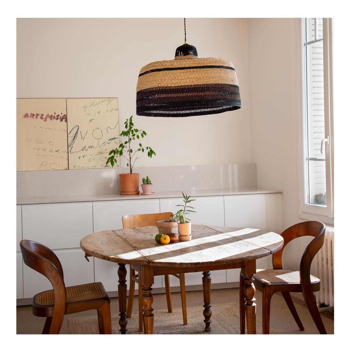 Large woven pendant lamp : 
Warm and earthy
Colour: Terracotta orange

Do you love handmade objects but are looking for something more elevated to hang in your room? This large pendant lamp with black, earthy orange and natural stripes will fill