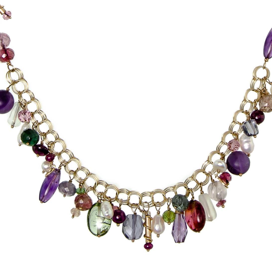 Attractive 14k yellow gold and multiple gemstone necklace containing multiple gemstones, cultured pearl, amethyst, garnet, ruby, tourmaline, beryl, peridot 14k yellow gold mount - hook clasp - by Designer, Eve Alfille (unsigned).  Contemporary