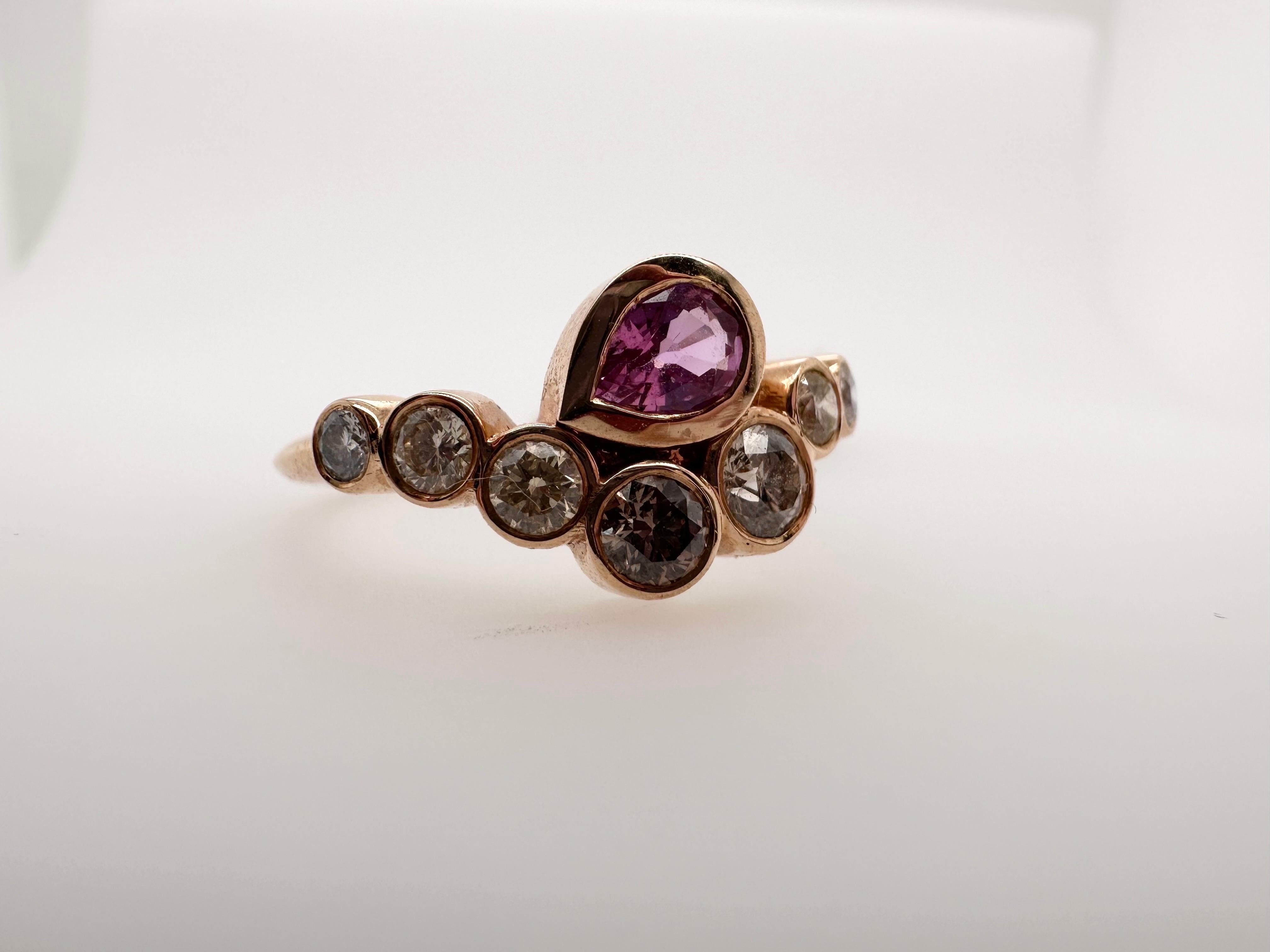 Exquisite Pink Sapphire and Diamond ring in 14KT rose gold, made in a contemporary evil eye style, very interesting artistic vision of the ring. 

Metal Type: 14KT

Natural Sapphire(s):
Color: Pink
Cut: Pear
Carat: 0.55ct
Clarity: Slightly