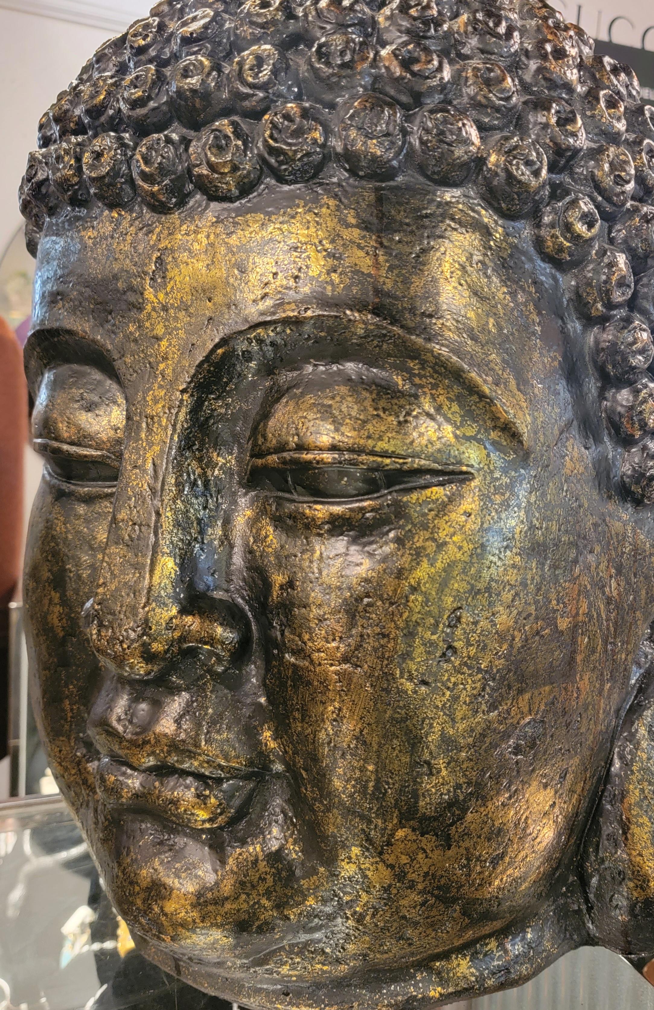 Large scale fiber glass buddha head with gold and black tones. Great pattern. This fiber glass buddha head is in great shape and has little to no wear.