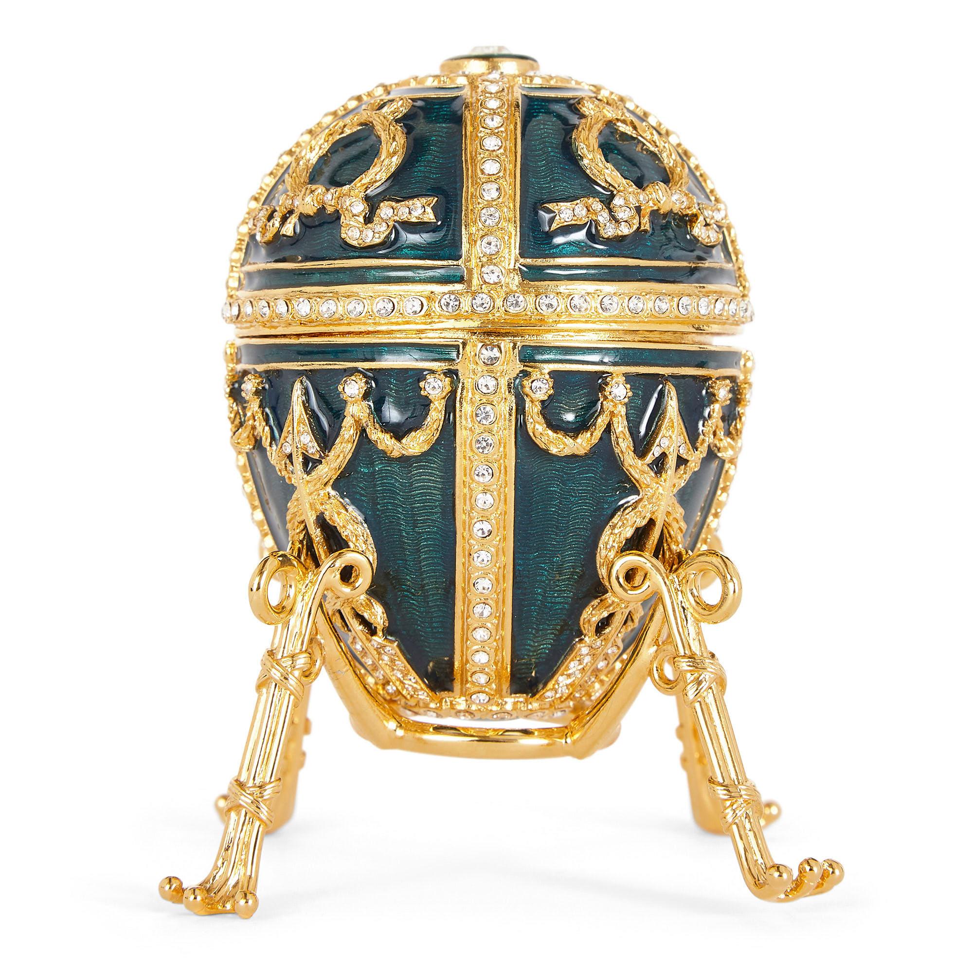 Contemporary Fabergé Easter egg with green Guilloché enamel and gemstones,
Late 20th century
Box: Height 10cm, width 16cm, depth 21cm
Egg on stand: Height 8cm, diameter 6cm

Standing on an elegant four-legged gilt metal stand, this beautiful