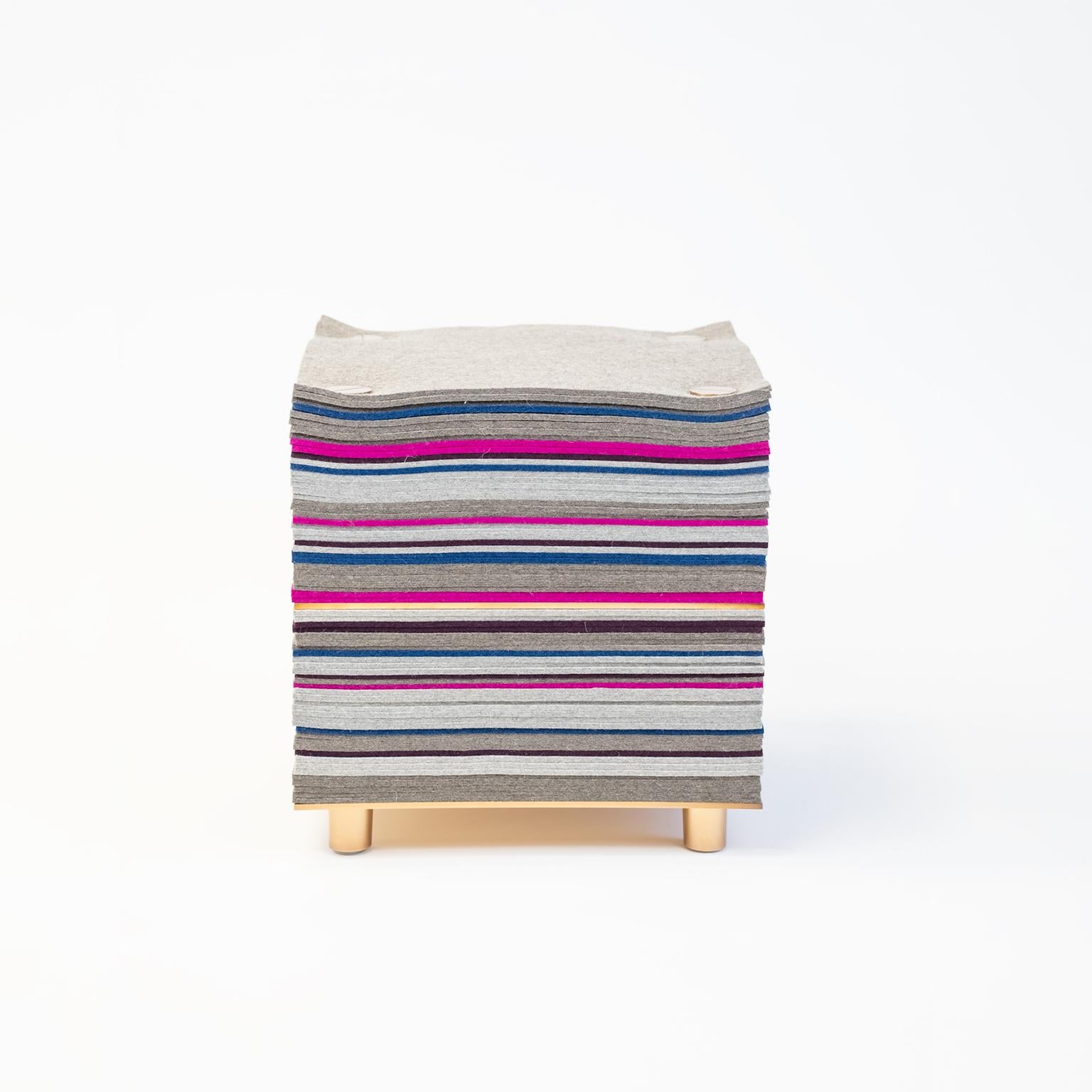 The Felt series stool features a plush seating surface made of layers of premium natural merino wool felt. The stack is held together by STACKLAB’s signature plated-steel clamping hardware.

The felt stack mixes colored and grey layers. An