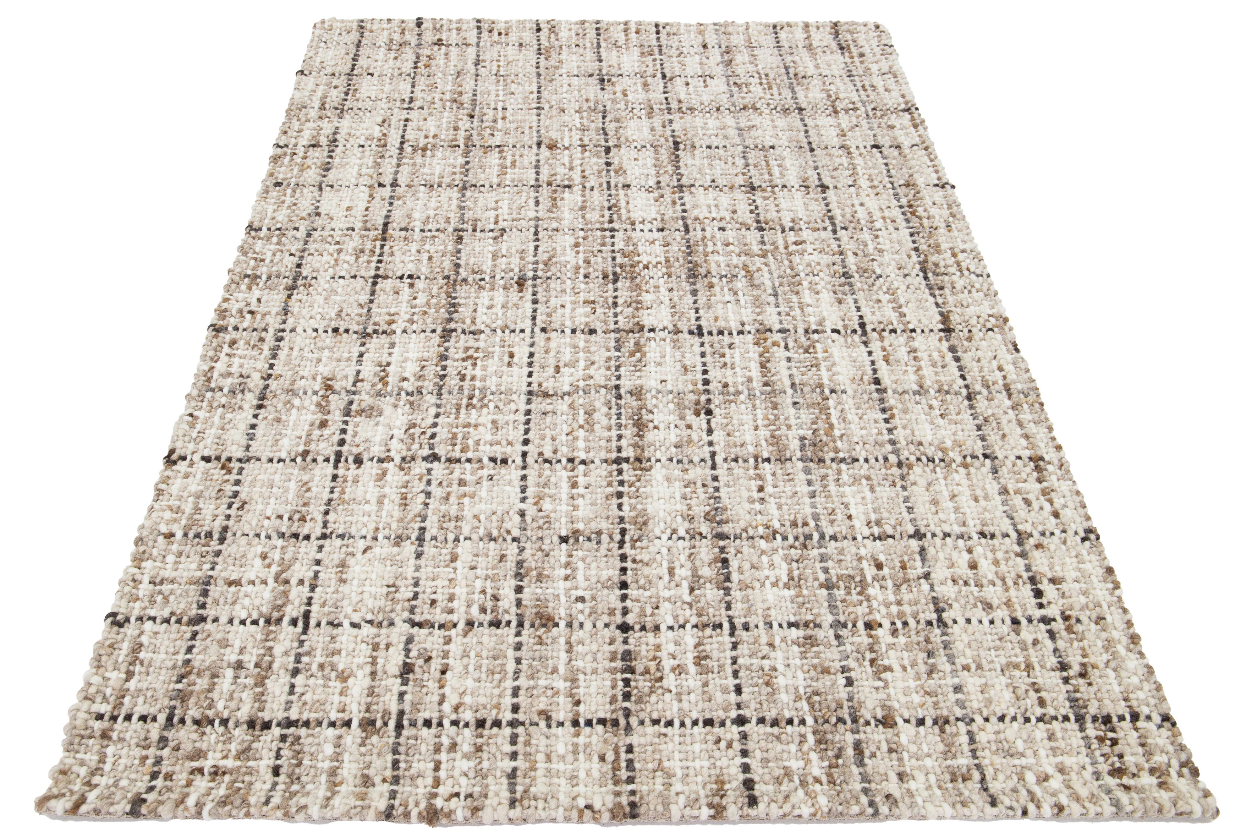 This beautiful Felt hand-woven wool rug is part of our Westport Collection. It has an Ivory color field and a brown and gray all-over geometric design.

This rug measures 5' x 8'.

Custom colors and sizes are available upon request.

