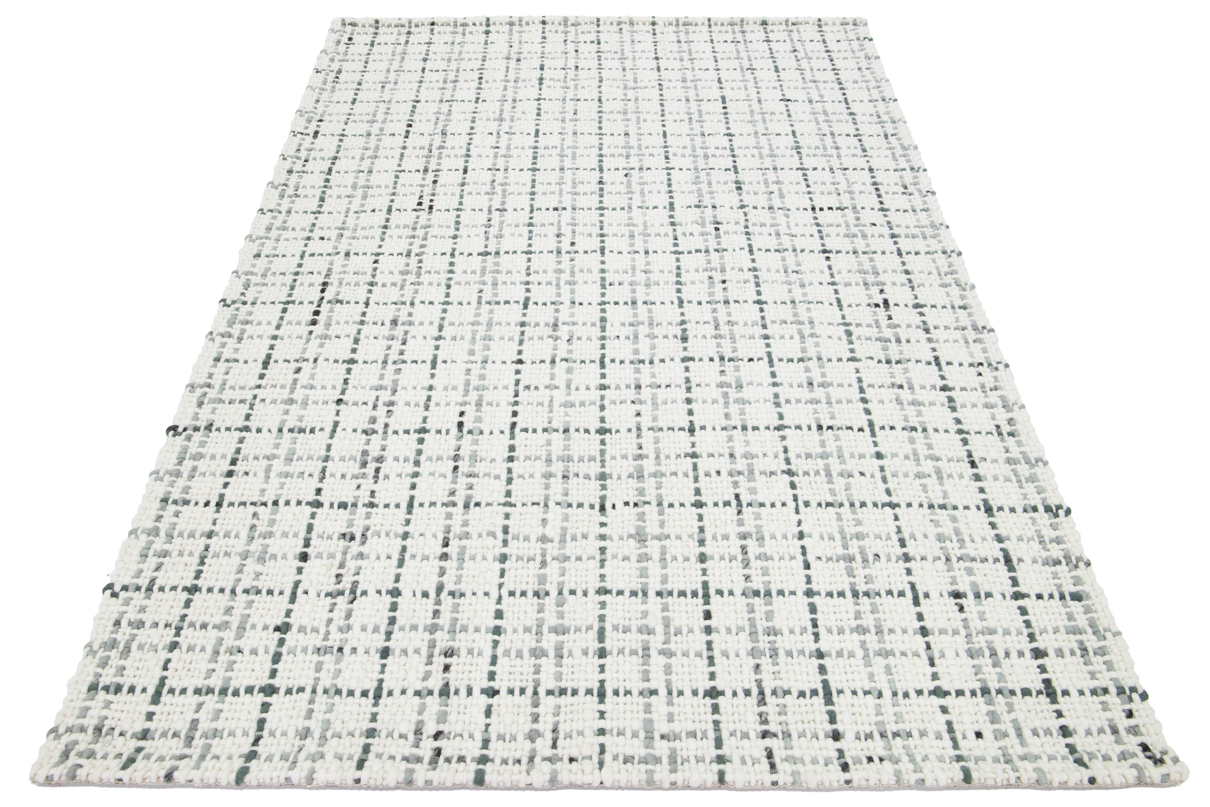 This beautiful Felt hand-woven wool rug is part of our Westport Collection. It has an Ivory color field and a gray all-over geometric design.

This rug measures 5' x 8'.

Custom colors and sizes are available upon request.

