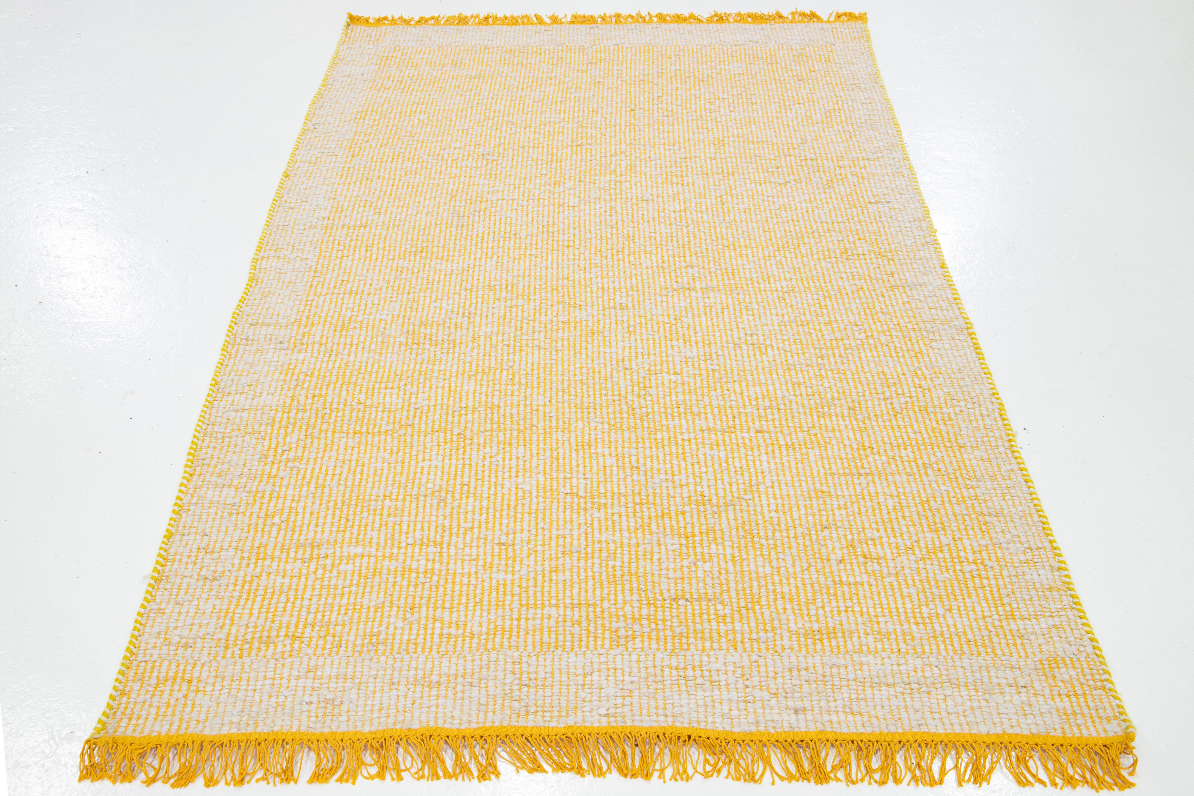 This beautiful Felt hand-woven wool rug is part of our Westport Collection. It has a yellow field and an ivory all-over geometric design with fringes.

This rug measures 5' x 8'.

Custom colors and sizes are available upon request.


