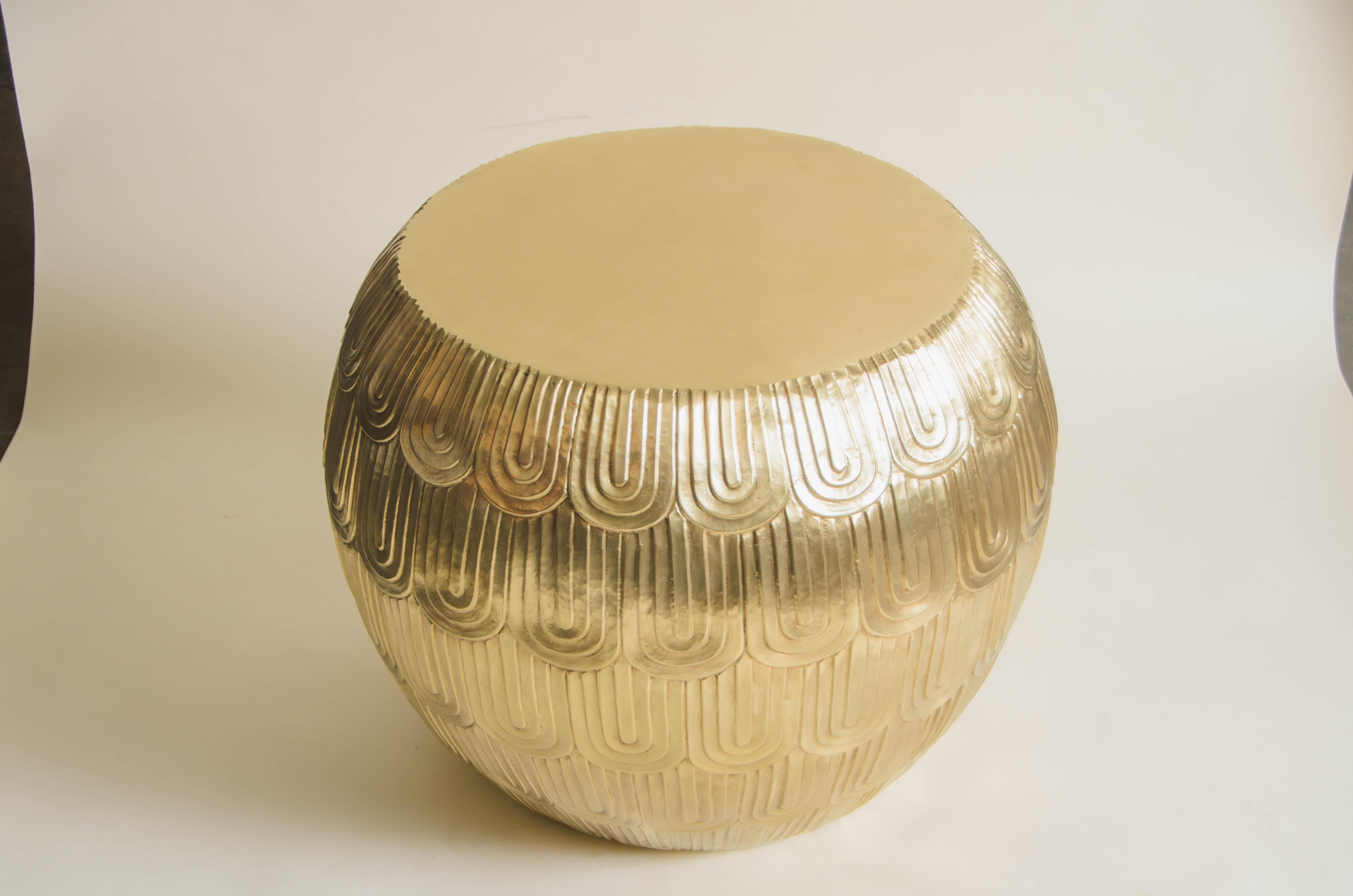 Fish scale design low drumstool
Brass
Hand Repoussé
Limited Edition
Contemporary

Repoussé is the traditional art of hand-hammering decorative relief onto sheet metal. The technique originated around 800 BC between Asia and Europe and in