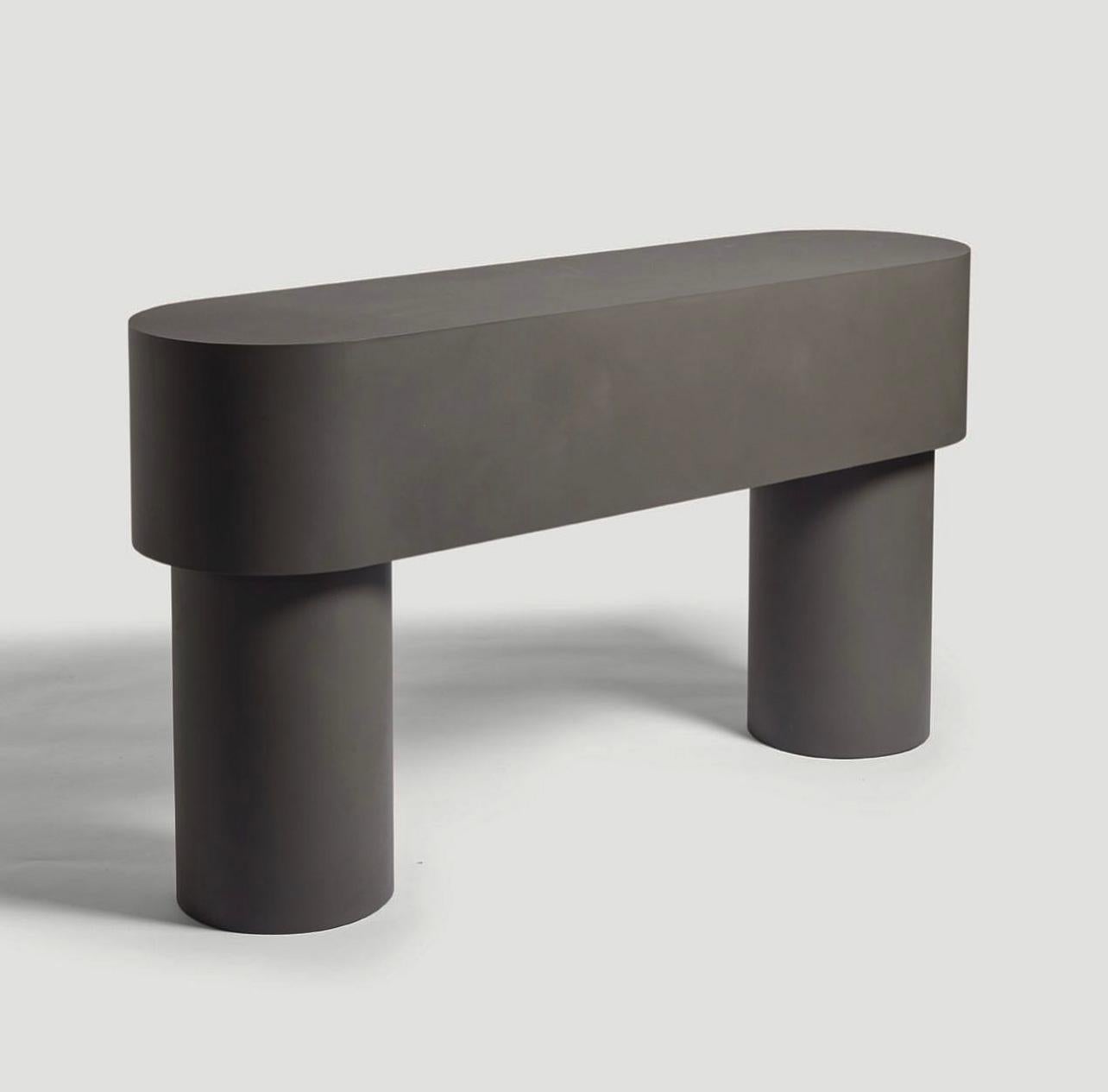Contemporary Jesmonite console - Pilotis console table by Malgorzata Bany.

Inspired by support columns that lift a building above ground or water. Each piece is formed using a mould made of paper, used only once, making each piece unique.