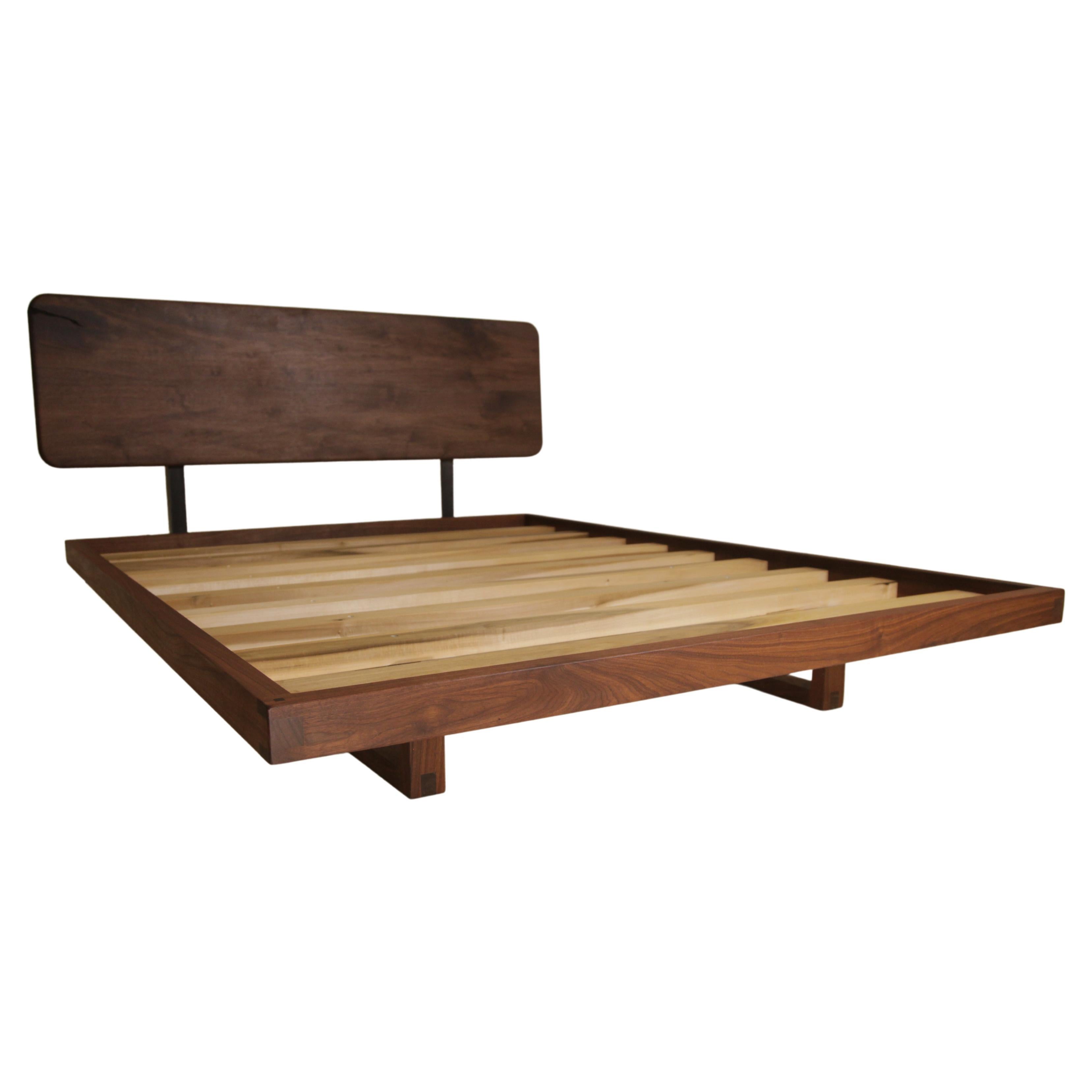 This contemporary walnut floating platform bed was originally designed for my own bedroom. It is priced and pictured as a queen with a dimensional walnut headboard, both the live edge and the dimensional headboards are seen and available. If