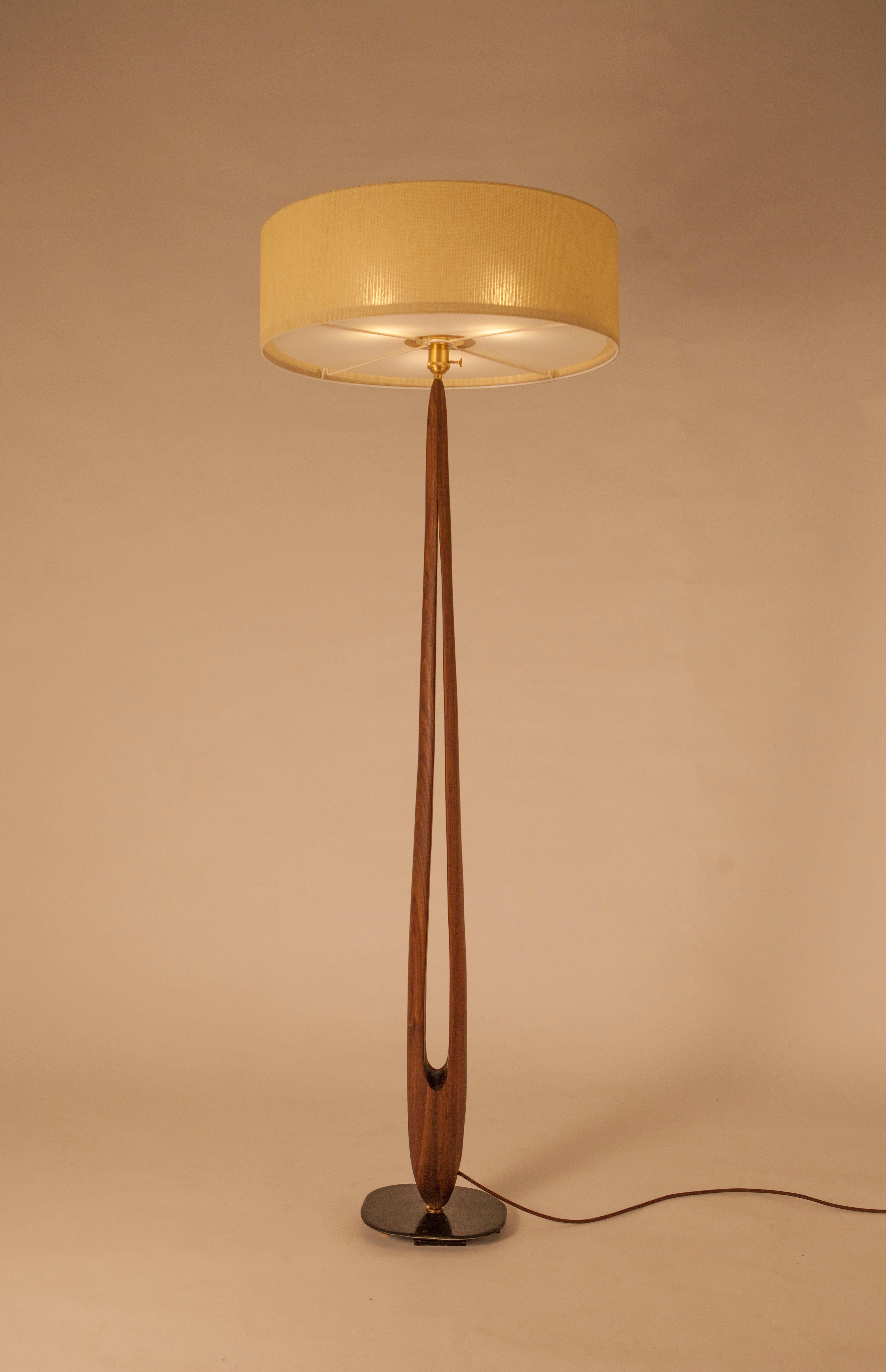 “Silent and powerful, between being and non-being, La Cigogne is the eye and the needle, the hollow of the wind, a breakthrough of light ...”

“La Cigogne” is a wooden floor lamp with a very refined line and a fabric shade. The orifice along the