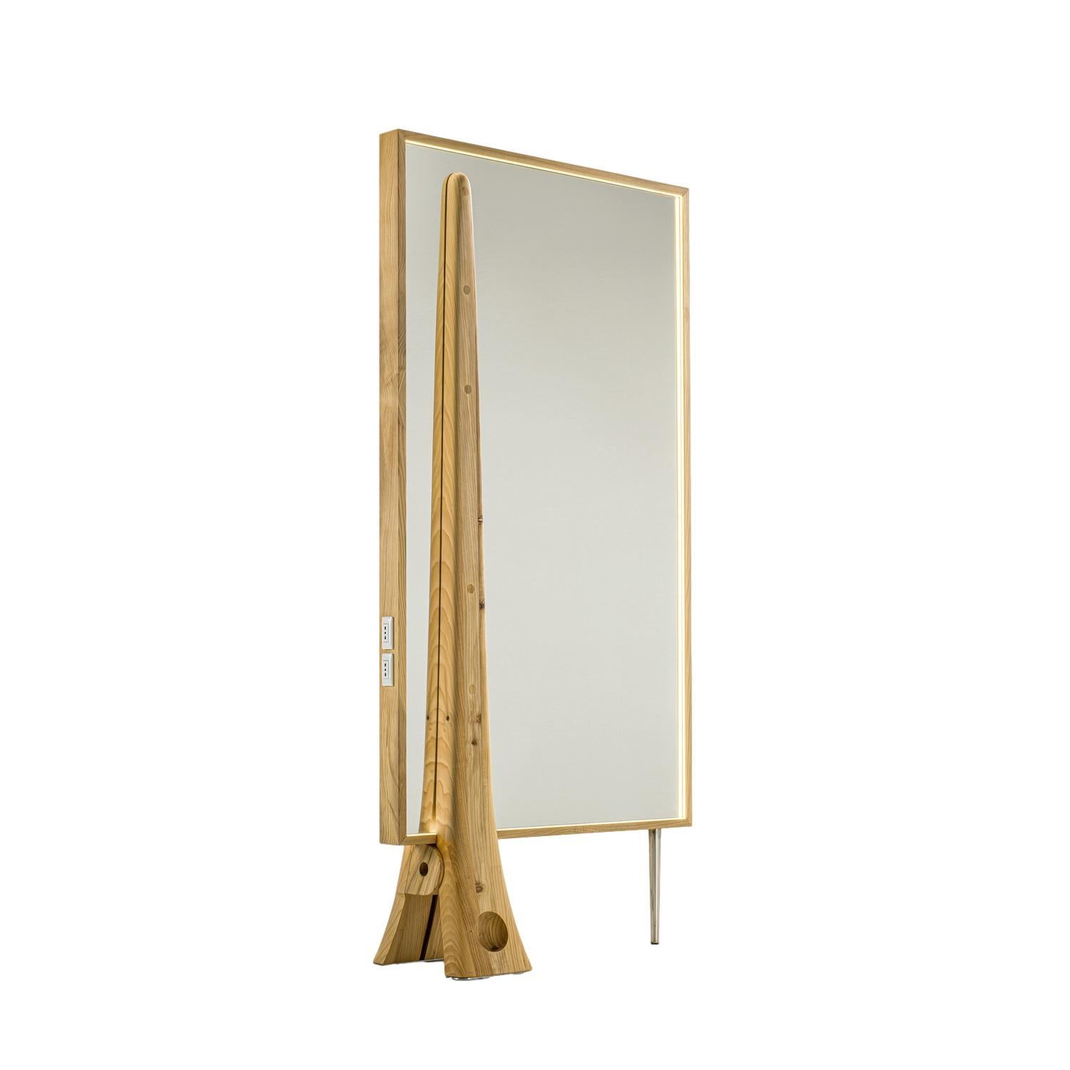 Crafted from solid scented cedar wood, this mirror is a tribute to an iconic hairstyling essential: the hair clip. Aldo Coppola Jr.'s visionary design transforms the humble clip into a sculptural cedar structure, artfully supporting a large mirror