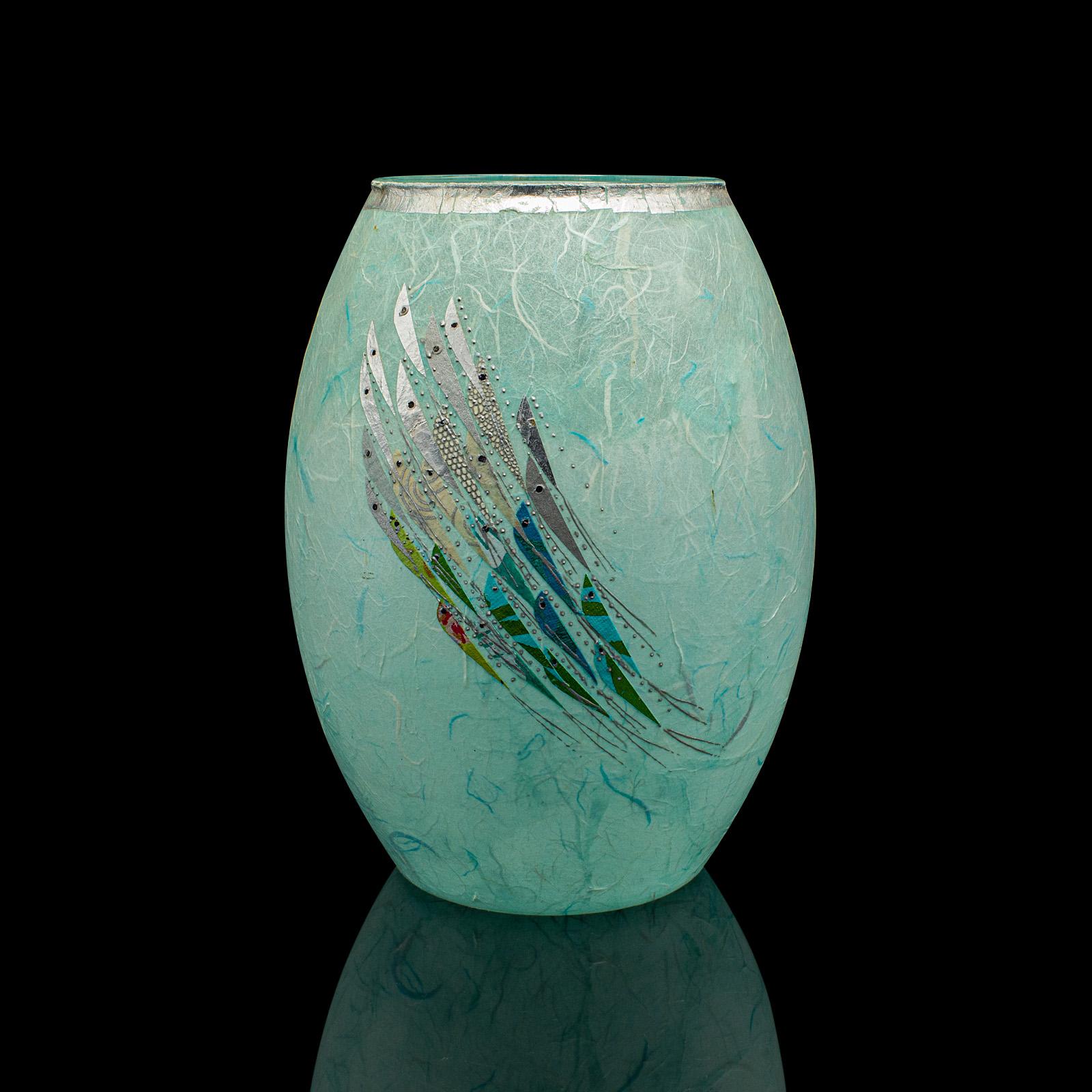 This is a contemporary flower vase. An English, art glass and straw silk decorative urn by Margaret Johnson.

Delightful colour with shimmering silver highlights
Displaying a desirable, contemporary appearance
Attractive glass beams in the light,