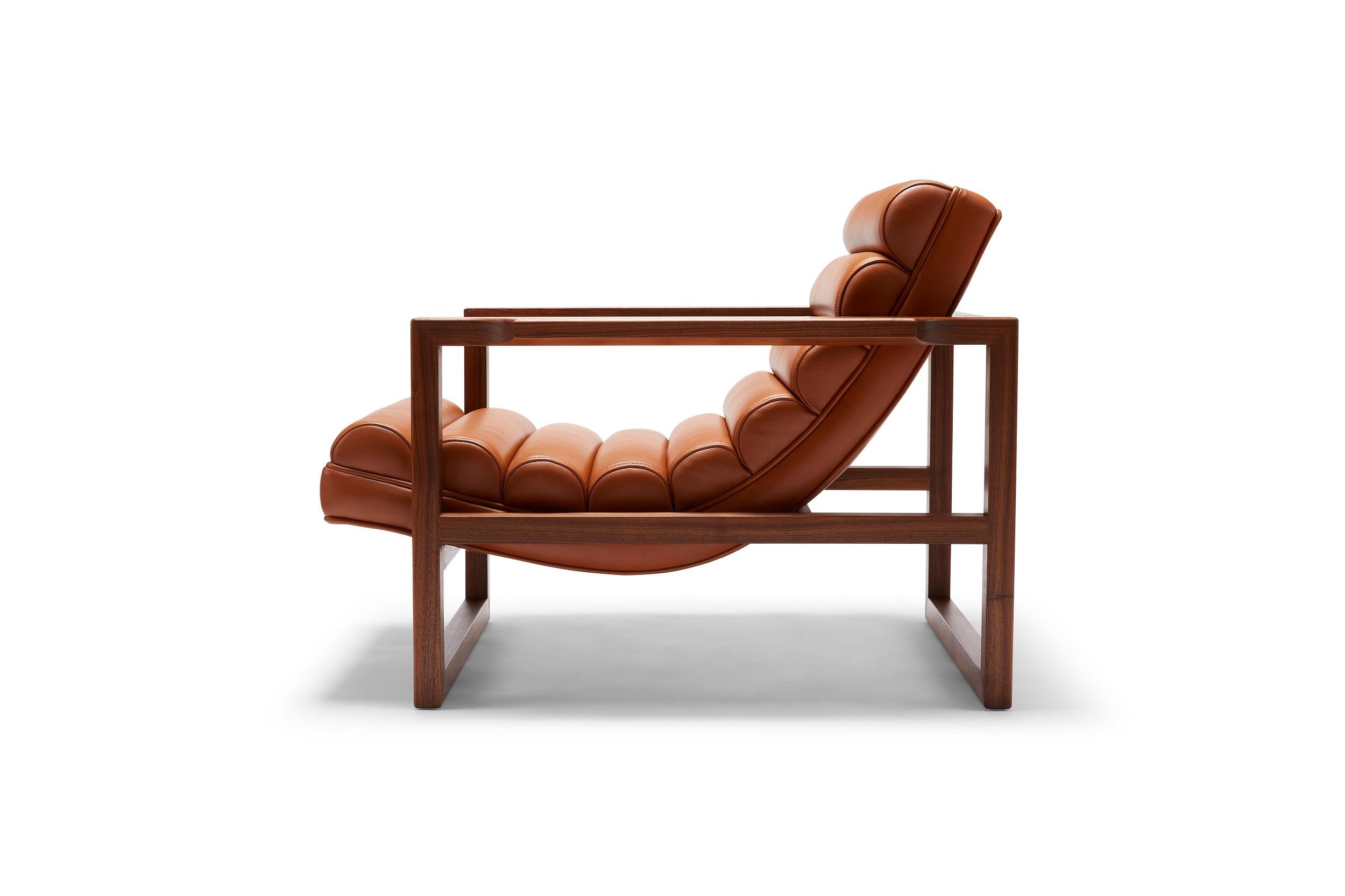 Created with the ultimate lounging comfort in mind and featuring a subtly detailed oiled walnut frame, the Florence is pure statement. It works well upholstered in fabric but our recommendation is lustrous leather in a bold color. Shown here in
