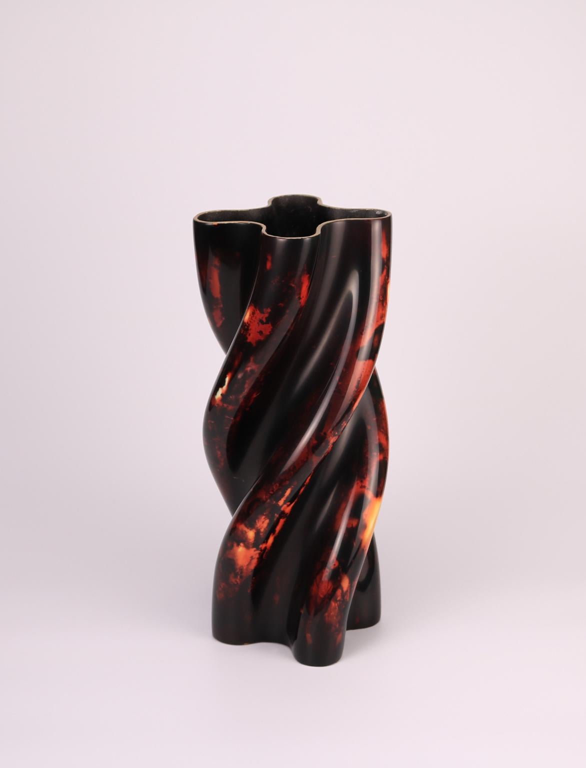 Contemporary lacquered ceramic vessel by Golem of Italy, handmade ceramic body sinuously shaped with four twirling lobes running from top to bottom, external decoration in museum quality lacquer, a perfectly smooth gloss finish and a very warm color