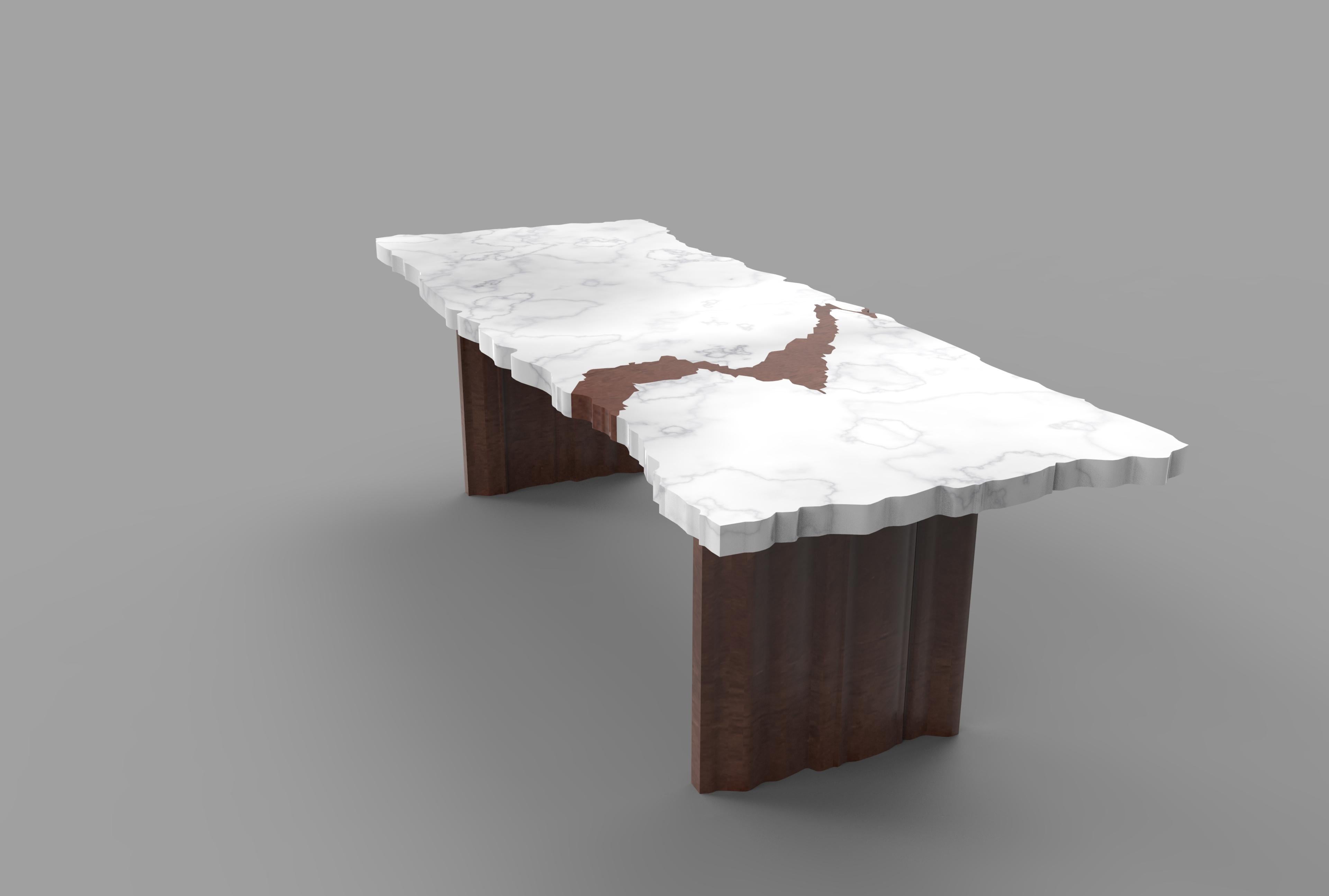 The FRAK-tur bespoke table is designed by Nathalie Ryan. The rectangular table top is made in handcut Carrara marble with a wedge of wood inserted inspired by the natural cracks of the marble; the feet are made in walnut wood. The table is fully