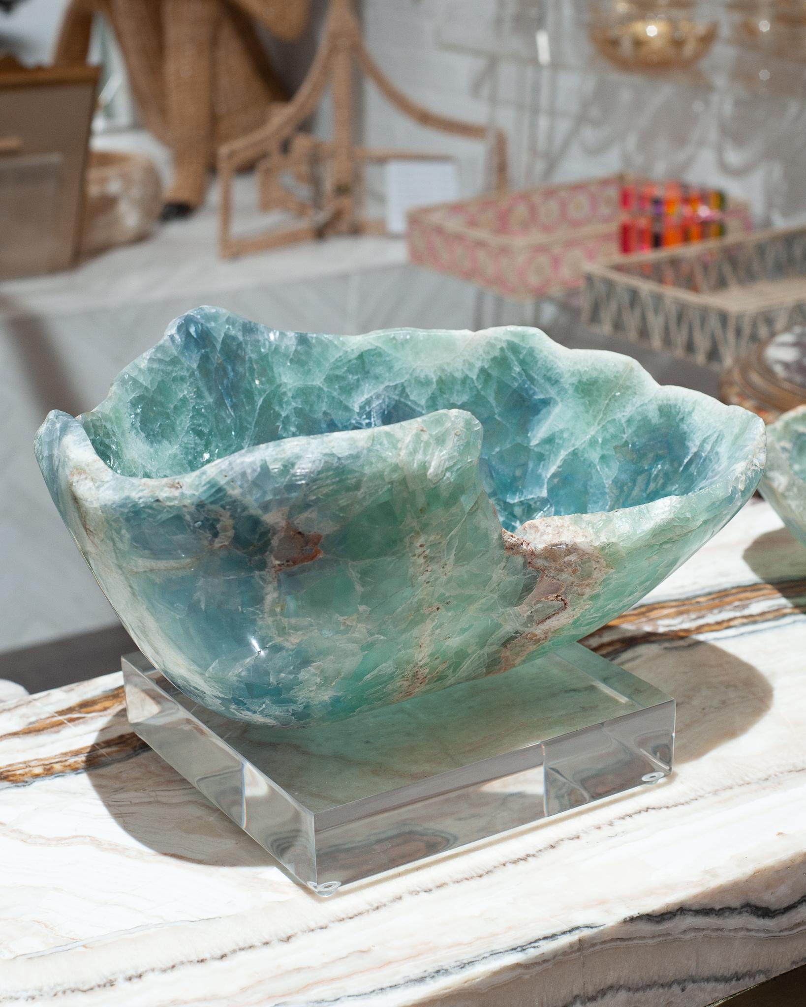 Invite the healing energy of fluorite into your home with an exceptional mineral bowl. This semi-precious stone is banded with green and blue and a natural raw edge.