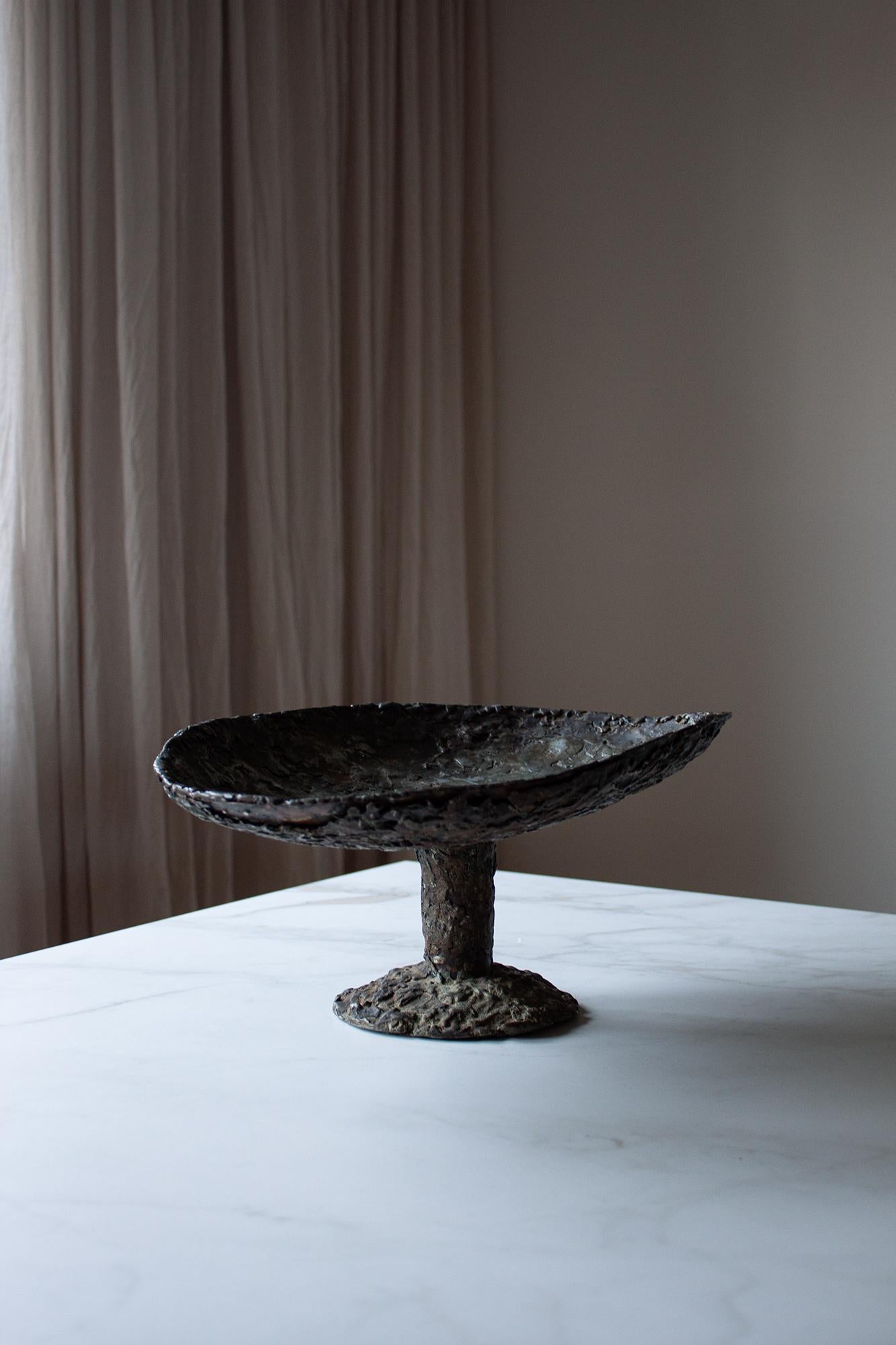 This Unique piece of artisan-made metal Bowl is a fusion of modern design and craftsmanship. Handcrafted by a skilled artisan in France, this unique bowl exemplifies the raw beauty of Brutalist design.

Crafted from metal and iron, the bowl features