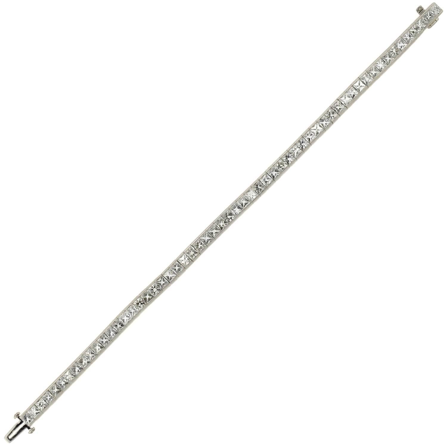 An absolutely exquisite Art Deco style diamond line bracelet! This stunning platinum piece features a row of 58 French Cut diamonds, which carry seamlessly around the wrist to create a stunning and flexible design. The sparkling stones exhibit D-F