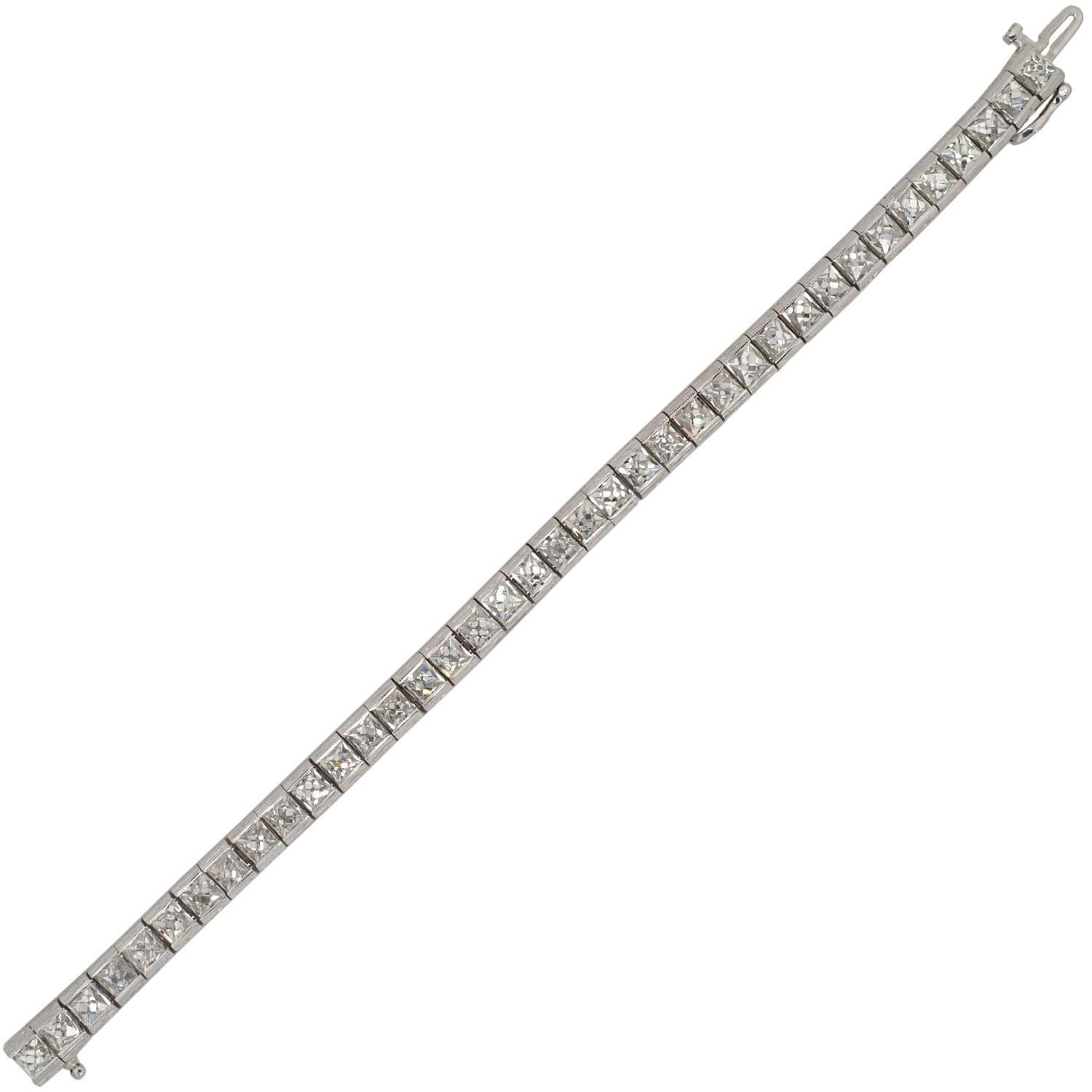 An absolutely exquisite Art Deco style diamond line bracelet! This stunning platinum piece features a row of 38 French Cut diamonds, which carry seamlessly around the wrist to create a stunning and flexible design. The sparkling stones exhibit E-F