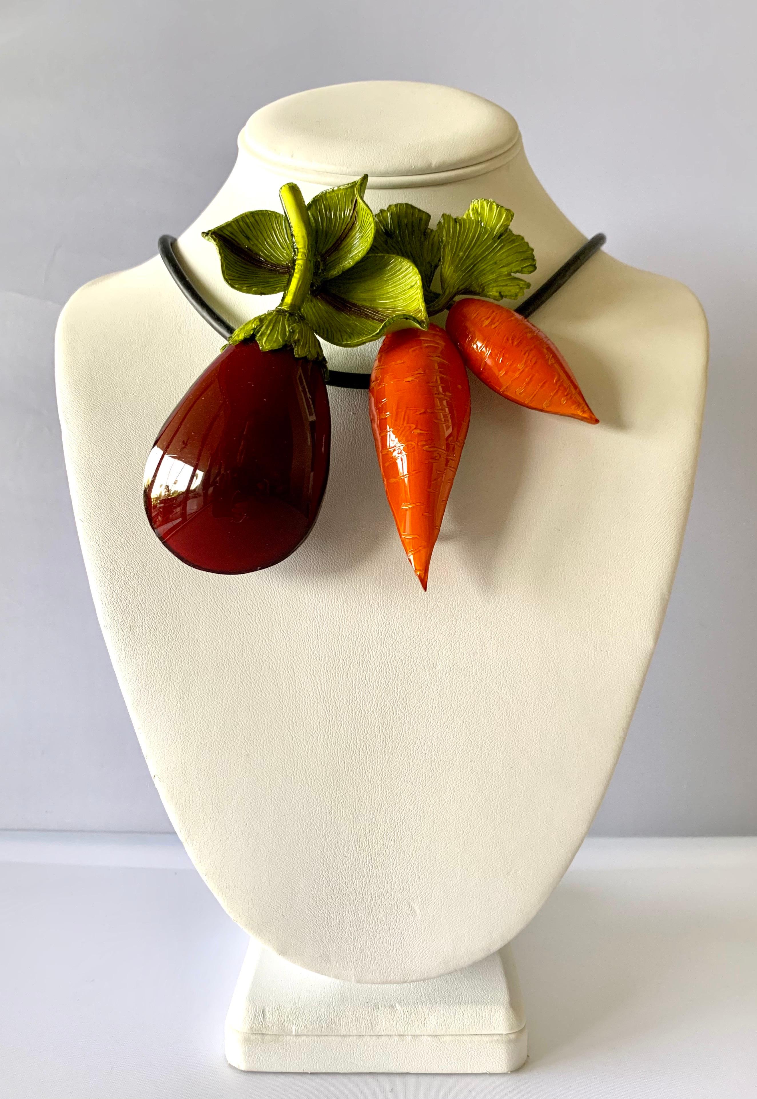 Contemporary French designer fruit and vegetable statement necklace - the statement necklace is comprised out of a black rubber cord that is embellished by carrots, and an eggplant. The piece can be worn as a necklace or the items individually as