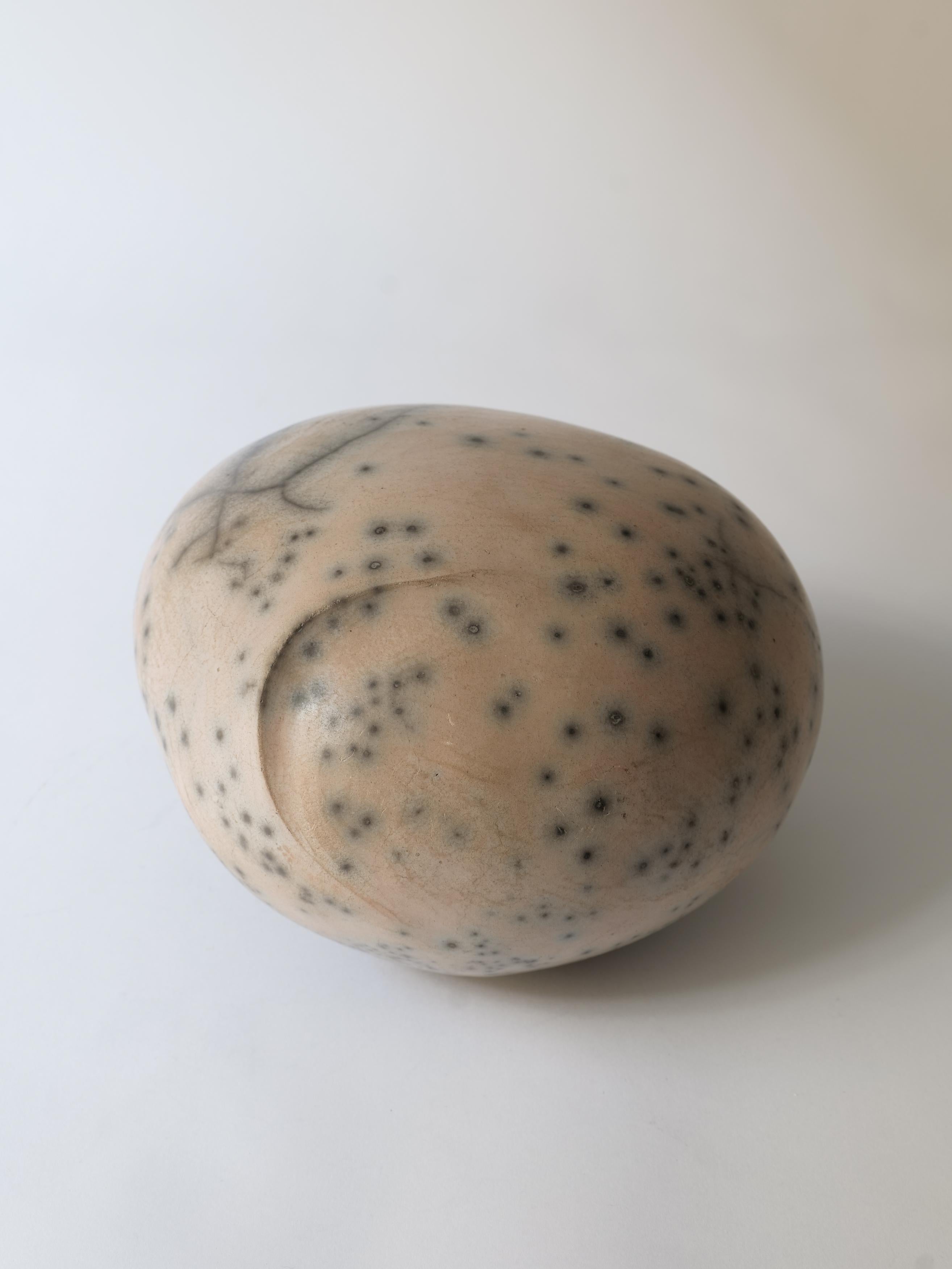A polished stoneware ceramic sculpture by the contemporary French ceramic artist, Dominic Legros. Reminiscent of wet pebbles in nature the smooth surface is created with intense hand polishing of the surface after firing to reveal variations and