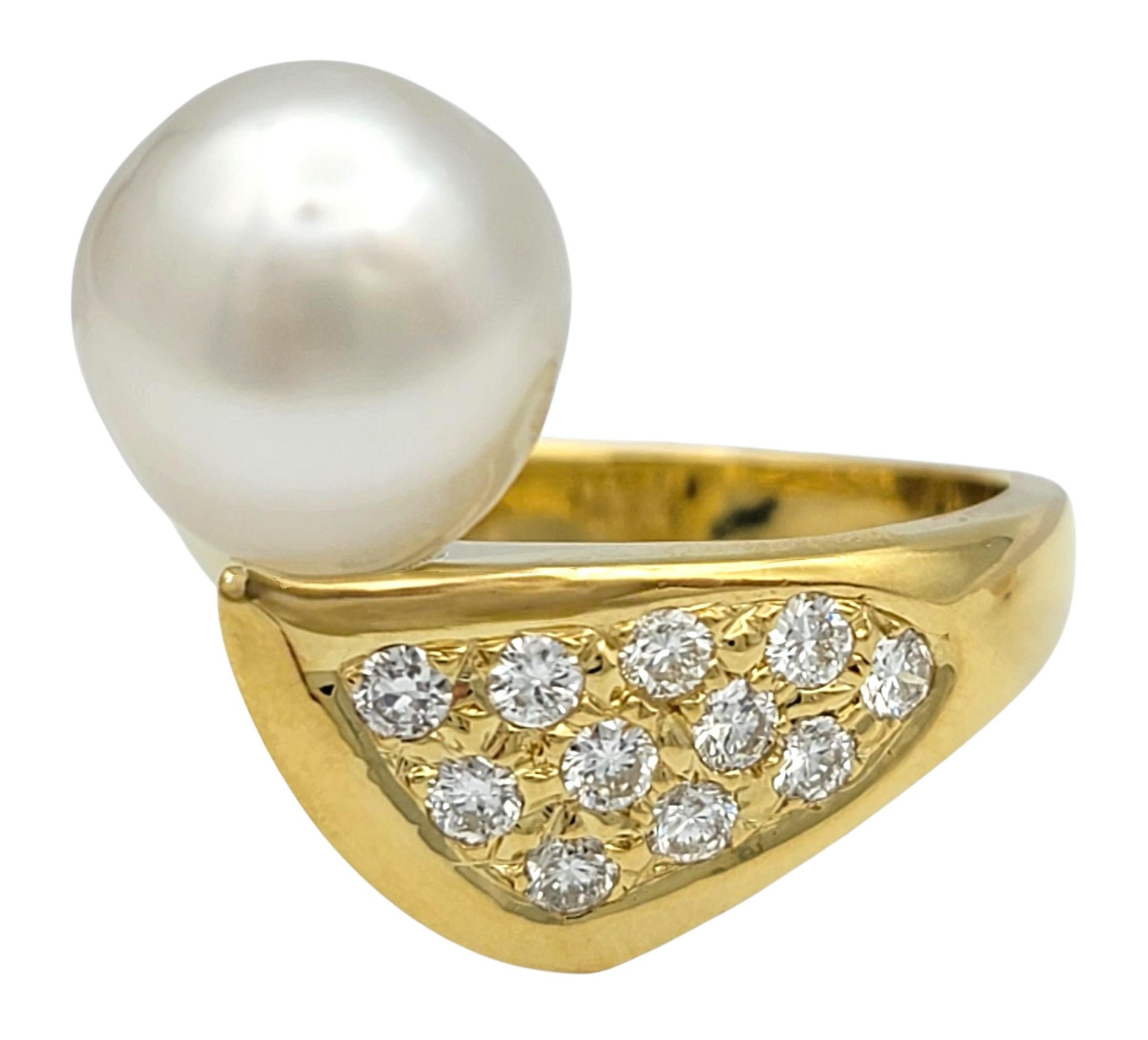 This exquisite ring showcases the timeless pairing of a luminous freshwater pearl with sparkling round brilliant cut diamonds. The pearl, with its radiant luster and elegant size, is gracefully complemented by a shimmering diamond-accented setting