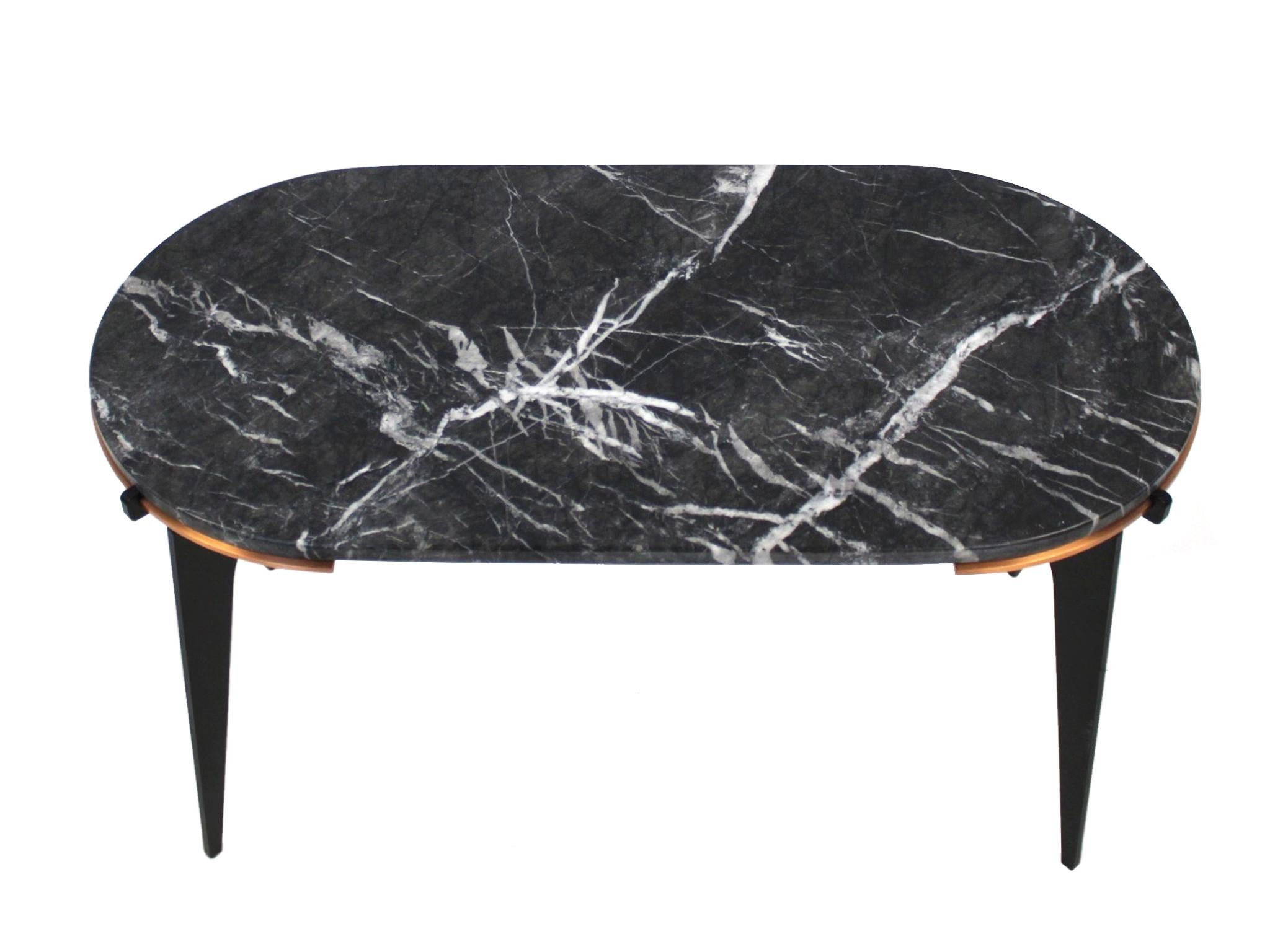 This contemporary hand-crafted side table is by Gabriel Scott and comes from their Prong series of furniture. It consists of a black marble top set into a metal base, which in turn is made of copper hardware and black steel legs. Structurally the