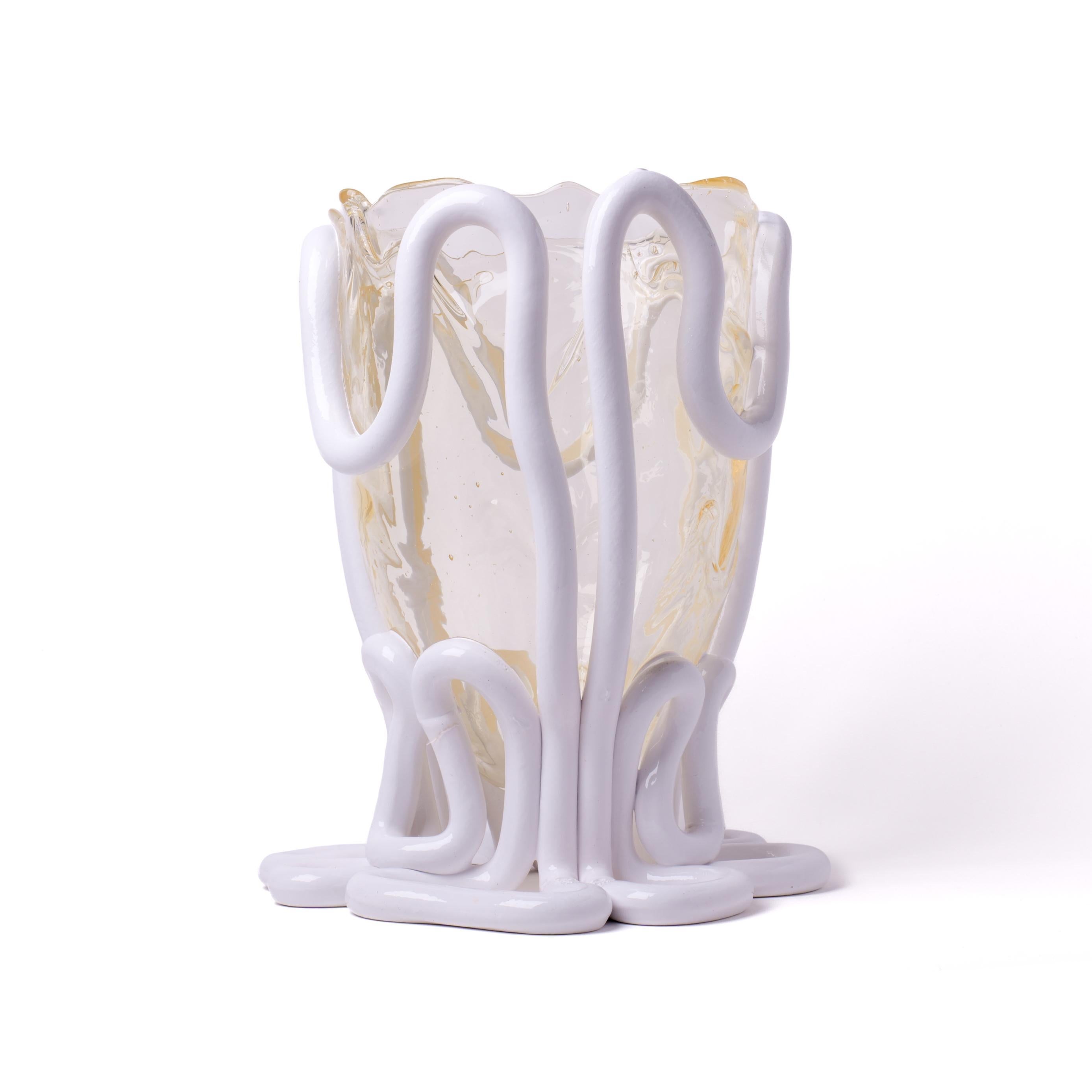 Indian Summer vase, clear and matt white.

Vase in soft resin designed by Gaetano Pesce in 1995 for Fish Design collection.
Measures: L - ø 22cm x H 36cm.
Colours: clear and matt white

Other sizes available.

Vase in soft resin designed by Gaetano