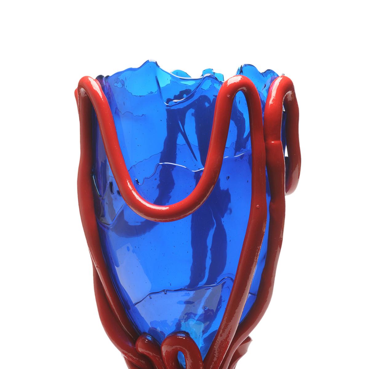 Indian Summer vase, clear blue, matt red

Vase in soft resin designed by Gaetano Pesce in 1995 for Fish Design collection.
Measures: M - ø 16cm x H 26cm
Other sizes available.
Colours: clear blue, matt red

Other sizes available.
Vase in soft resin