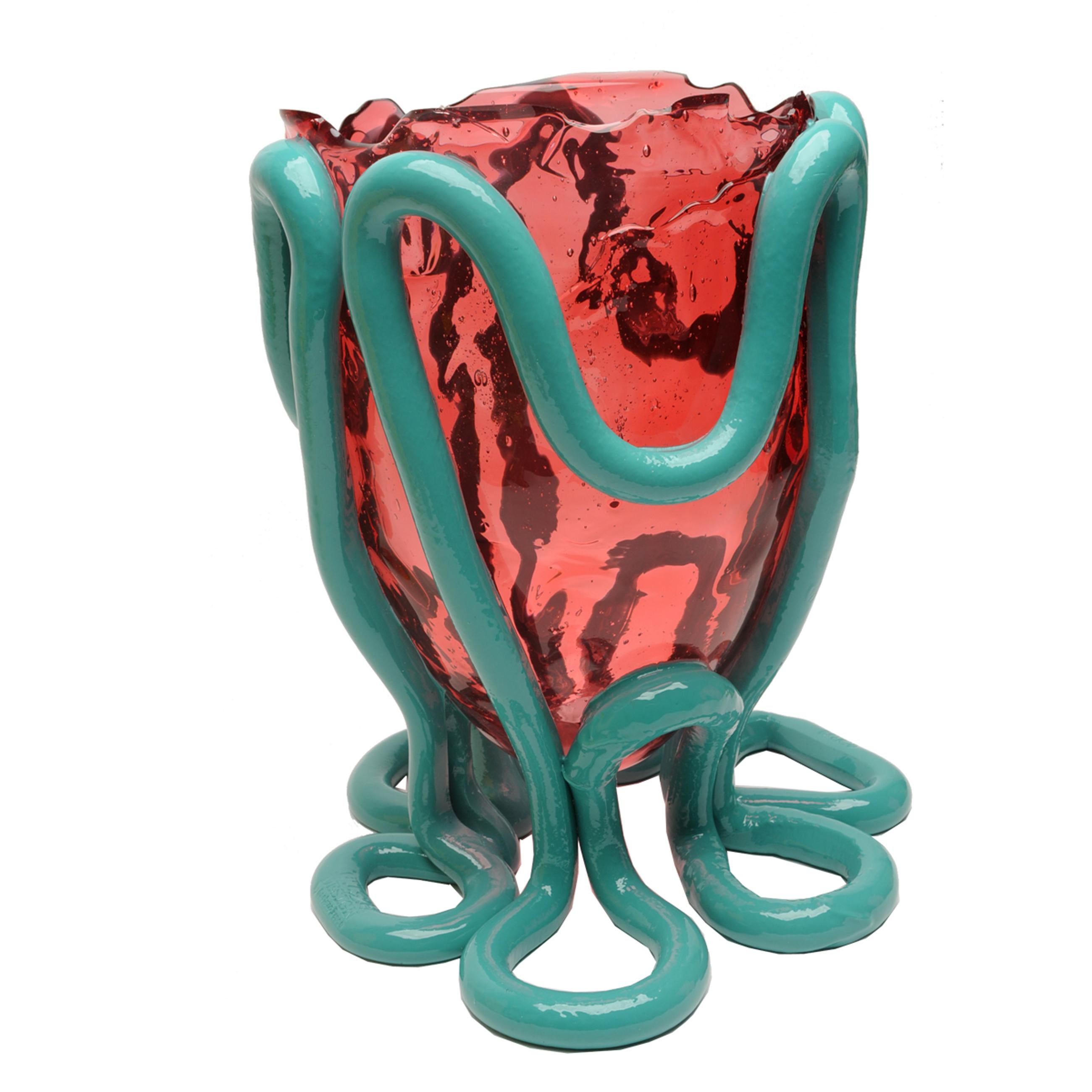 Indian Summer vase, clear light fuchsia and matt ocean blue.

Vase in soft resin designed by Gaetano Pesce in 1995 for Fish design collection.

Measures: M - ø 16cm x H 26 cm.

Other sizes available.

Colours: clear light fuchsia and matt ocean