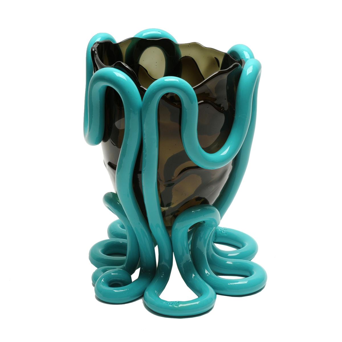 Indian Summer vase - Clear grey and matt turquoise

Vase in soft resin designed by Gaetano Pesce in 1995 for Fish Design collection.
Measures: M - ø 16cm x H 26cm
Colours: Clear grey and matte turquoise.

Other sizes available.
Vase in soft resin
