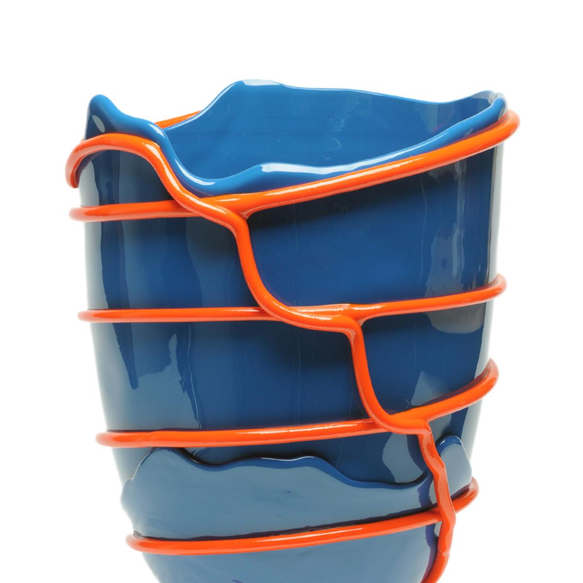 Pompitu II vase, blue, orange.

Vase in soft resin designed by Gaetano Pesce in 1995 for Fish Design collection.

Measures: L - ø 22cm x H 36cm

Other sizes available

Colours: Blue, orange.
Vase in soft resin designed by Gaetano Pesce in