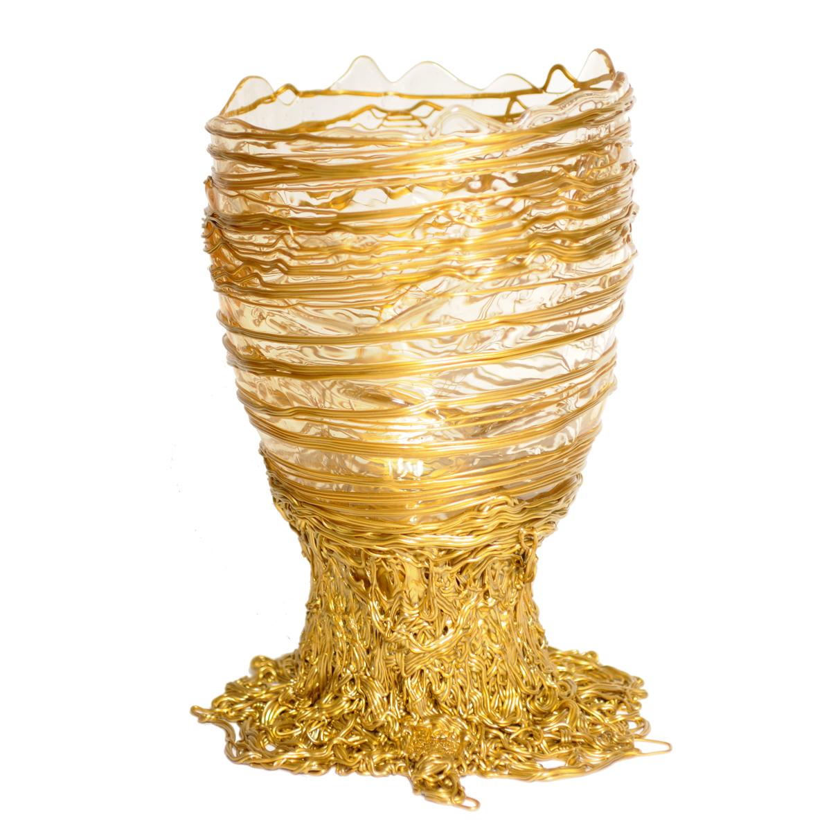 Spaghetti vase, clear and gold.

Vase in soft resin designed by Gaetano Pesce in 1995 for Fish Design collection.
Picture showing L size.
When ordering alternative sizes the proportions of the item will change.

Measures: L - ø 22cm x H