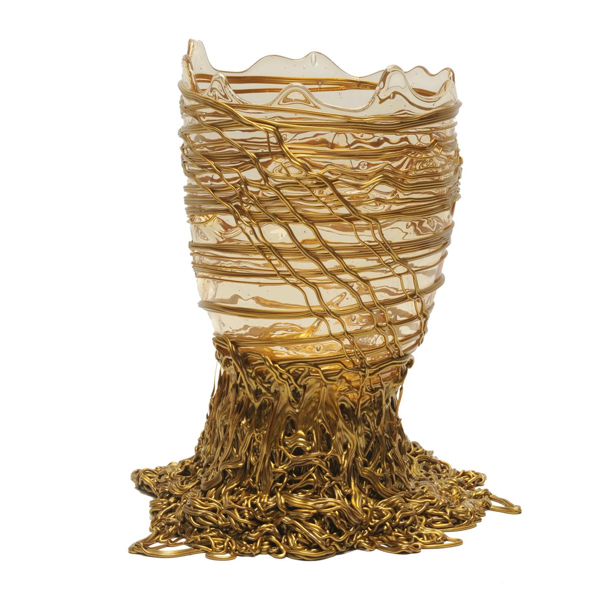 Spaghetti vase, clear and gold.

Vase in soft resin designed by Gaetano Pesce in 1995 for Fish Design collection.
Picture showing M size.
When ordering alternative sizes the proportions of the item will change.

Measures: M - ø 16cm x H