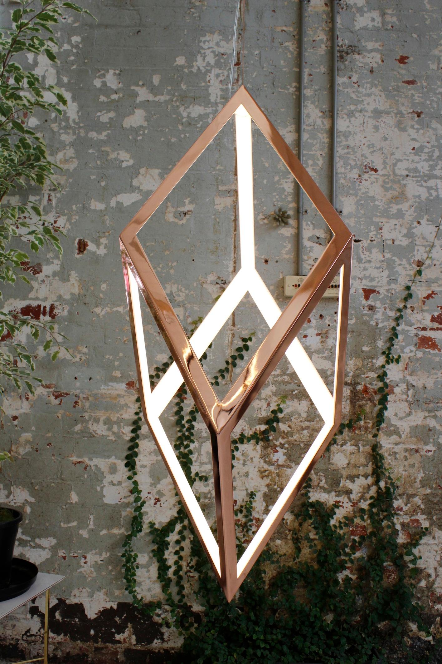 Contemporary Geometric brass or iron light pendant - ORP by Christopher Boots

Oblique Rhombic Prism is a pared-back structure that allows sacred geometry and light to come together as one. ORP emphasises simplicity and form, connecting elements