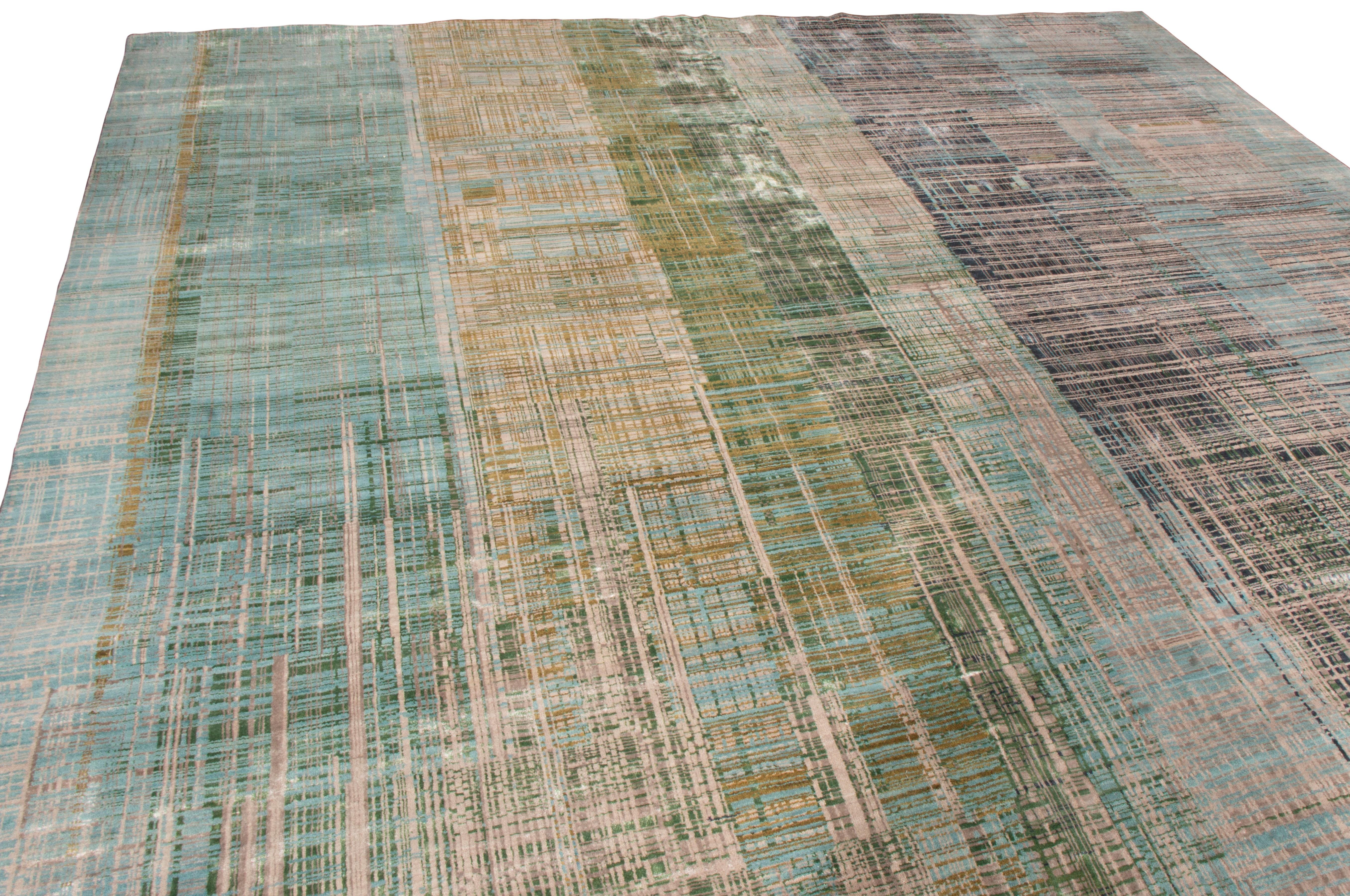 Originating from India, this contemporary geometric wool rug is hand knotted in high quality wool with a unique dual perspective to its colorways. The dominant hues of green and blue throughout the finely woven abstract scratch patterns also radiate